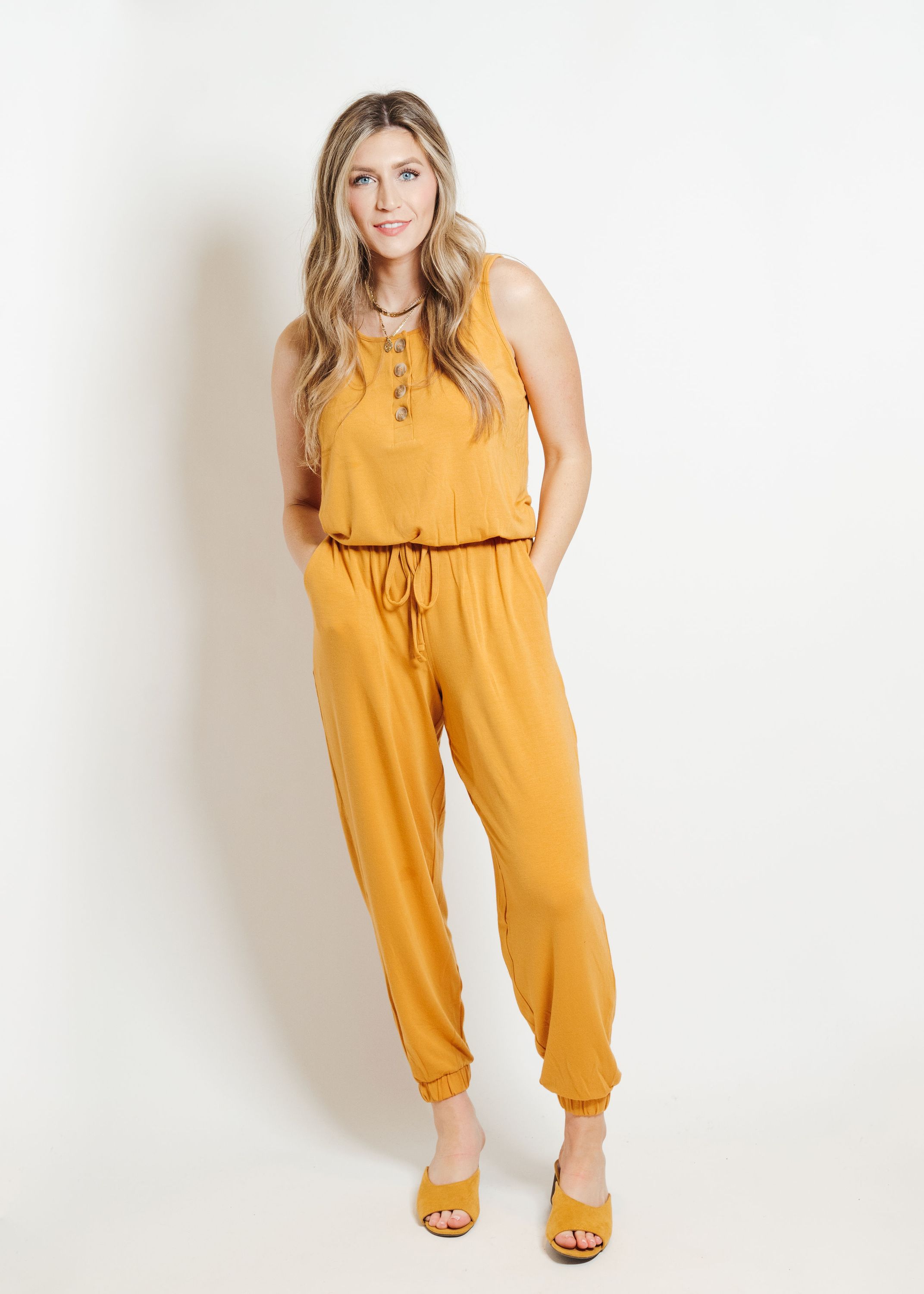 A stylish mustard-colored lounge jumpsuit displayed on a mannequin, showcasing its comfortable fit and trendy design.