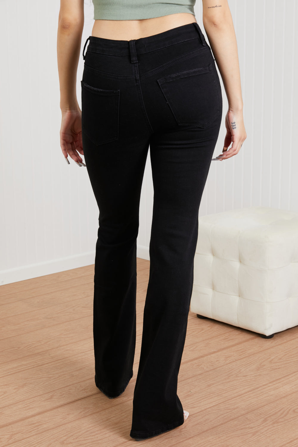 Lucia Bootcut Jeans displayed on a mannequin, showcasing the classic denim design with a flattering bootcut silhouette.