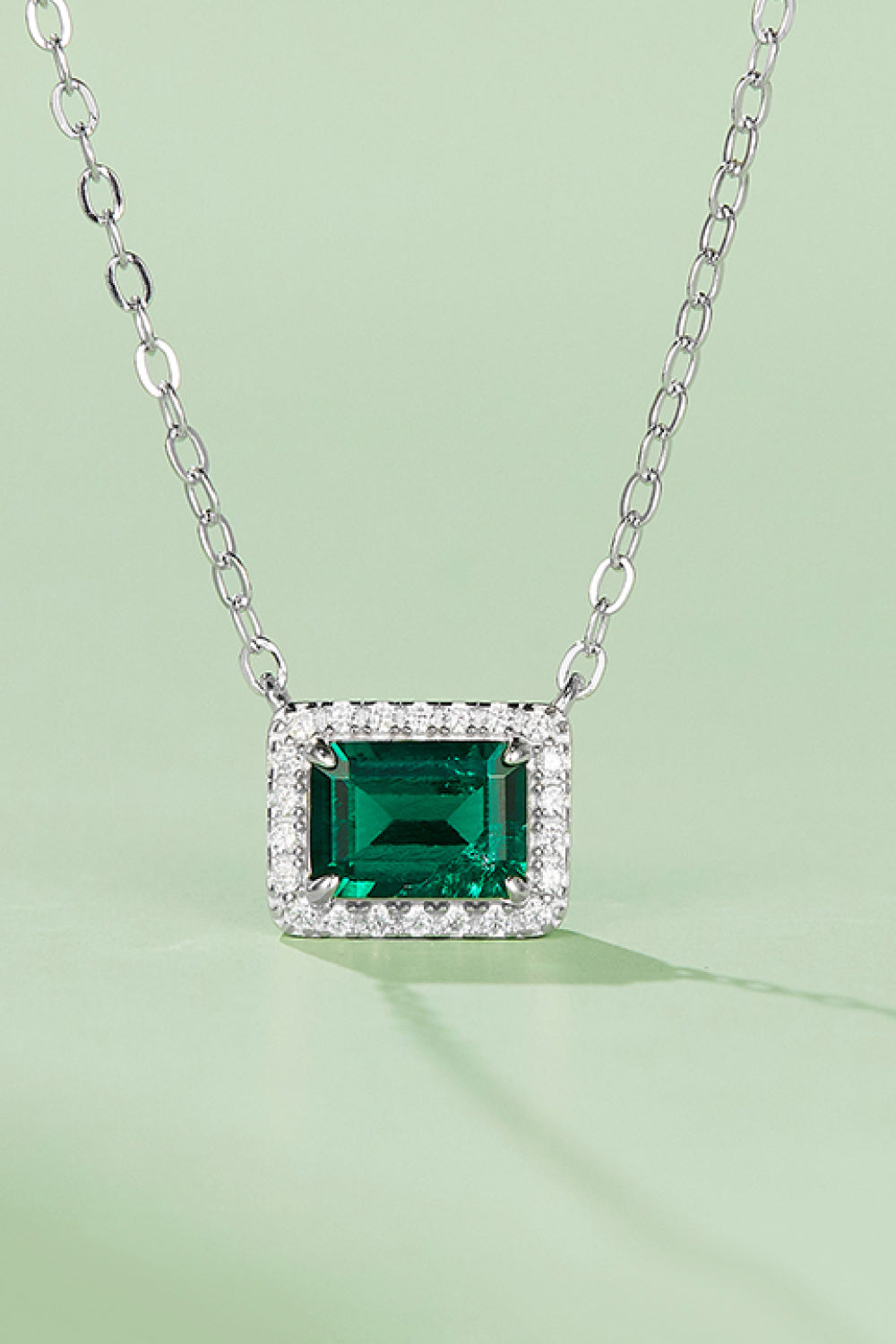 Lucky Girl Pendant Necklace featuring a lab-grown emerald set in 925 sterling silver with a platinum finish, elegantly displayed in a matching box.