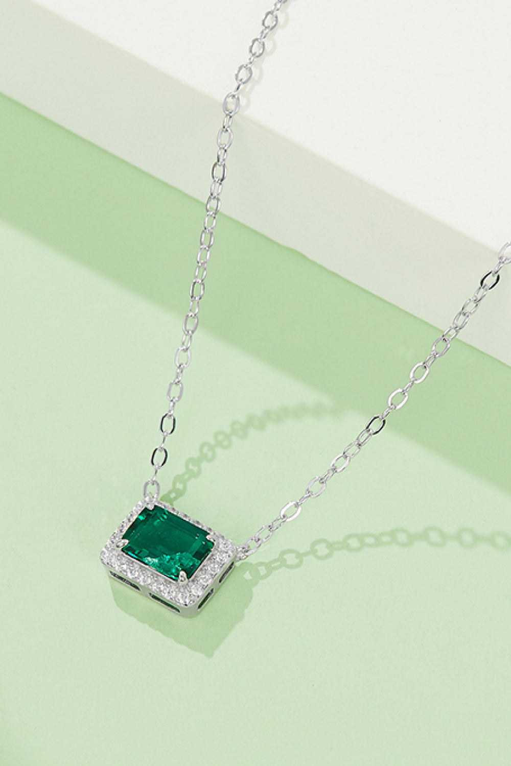 Lucky Girl Pendant Necklace featuring a lab-grown emerald set in 925 sterling silver with a platinum finish, elegantly displayed in a matching box.