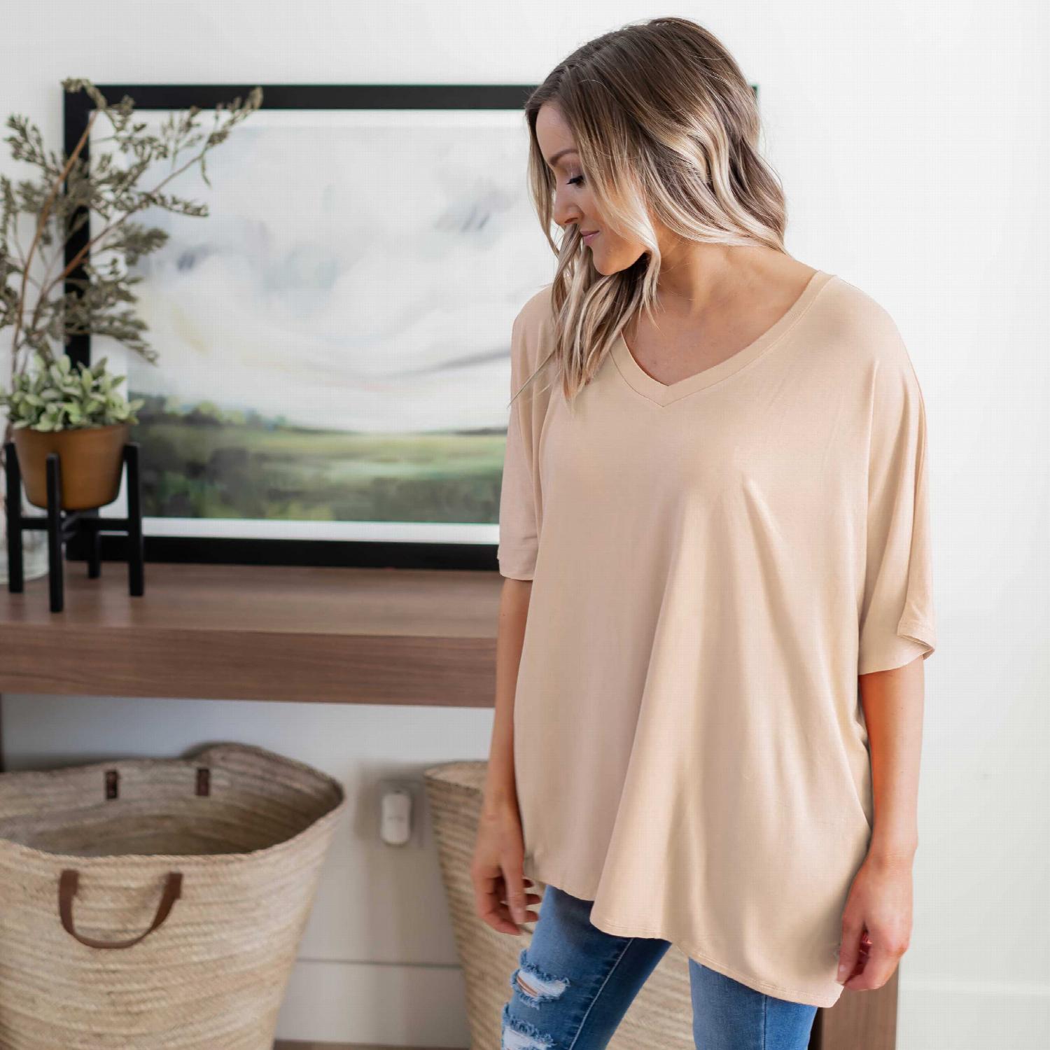 Luxe Rayon Dolman Half Sleeve V-neck Top in a stylish casual setting, showcasing its oversized design and flattering neckline.