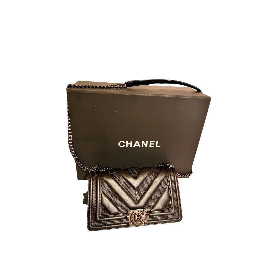 Luxury Chevron Quilted Flap Bag made of genuine leather with a silver chain strap and CHANEL logo on the front flap.