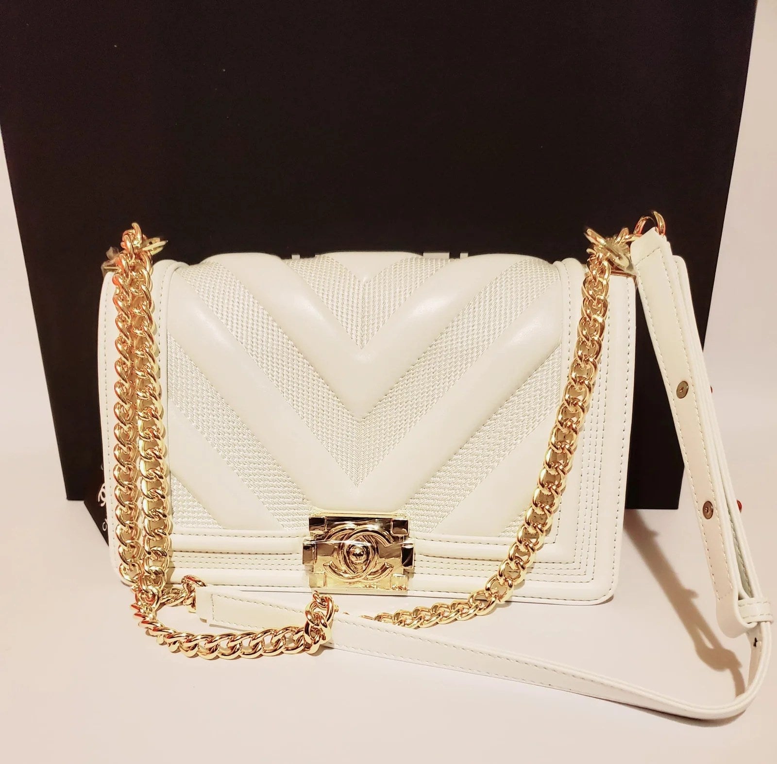 Luxury Chevron Quilted Flap Bag made of genuine leather with a silver chain strap and CHANEL logo on the front flap.