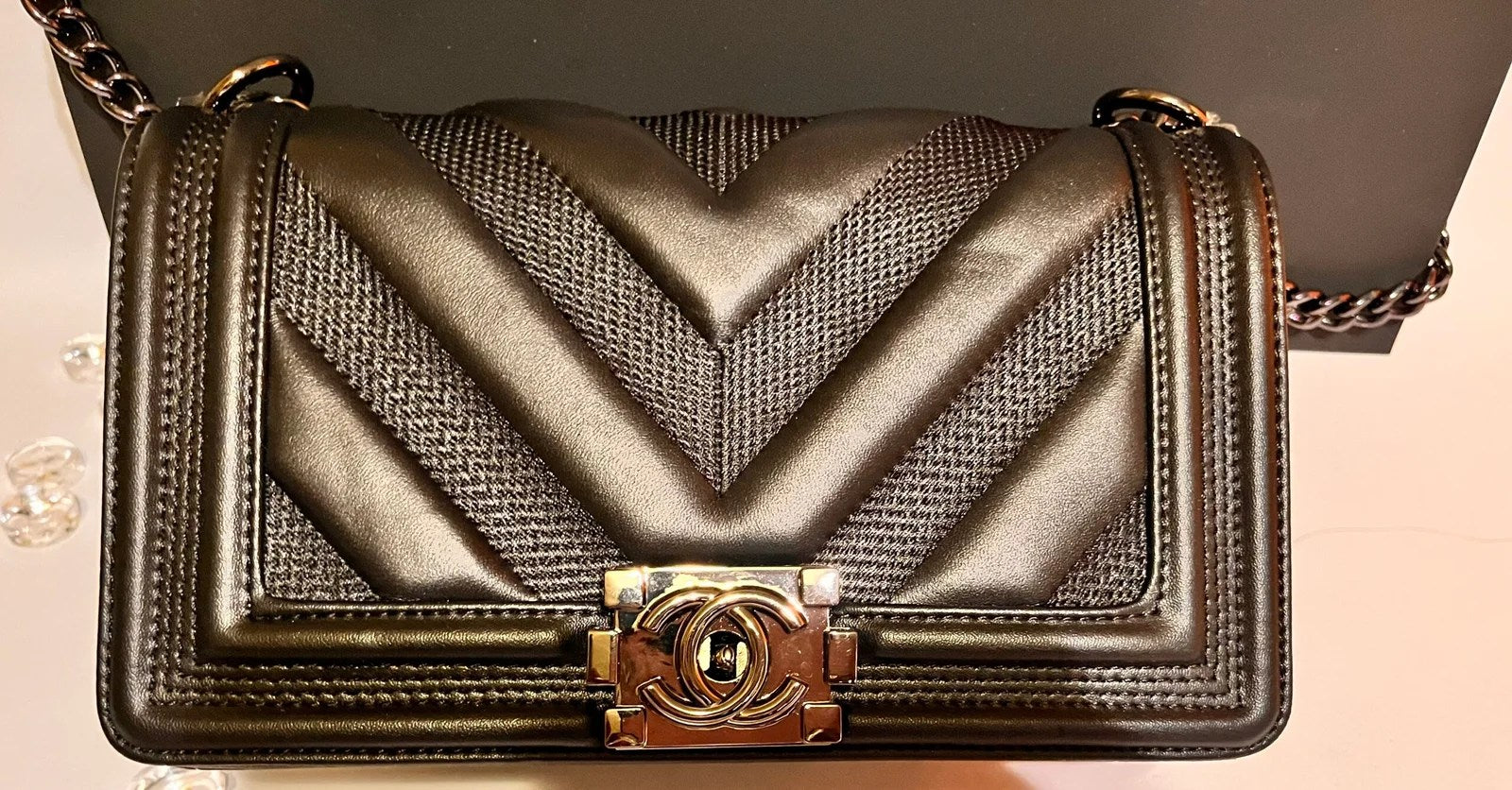 Luxury Chevron Quilted Flap Bag made of genuine leather with a silver chain strap and CHANEL logo on the front flap.