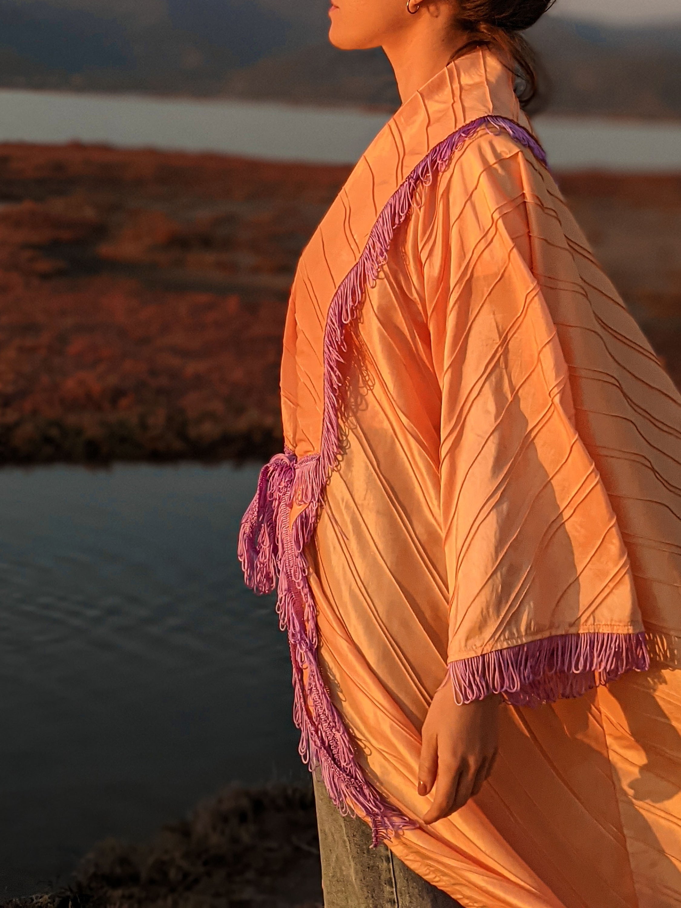 LYDAI salmon color taffeta outerwear with lilac fringes, showcasing elegant design and front closure detail.