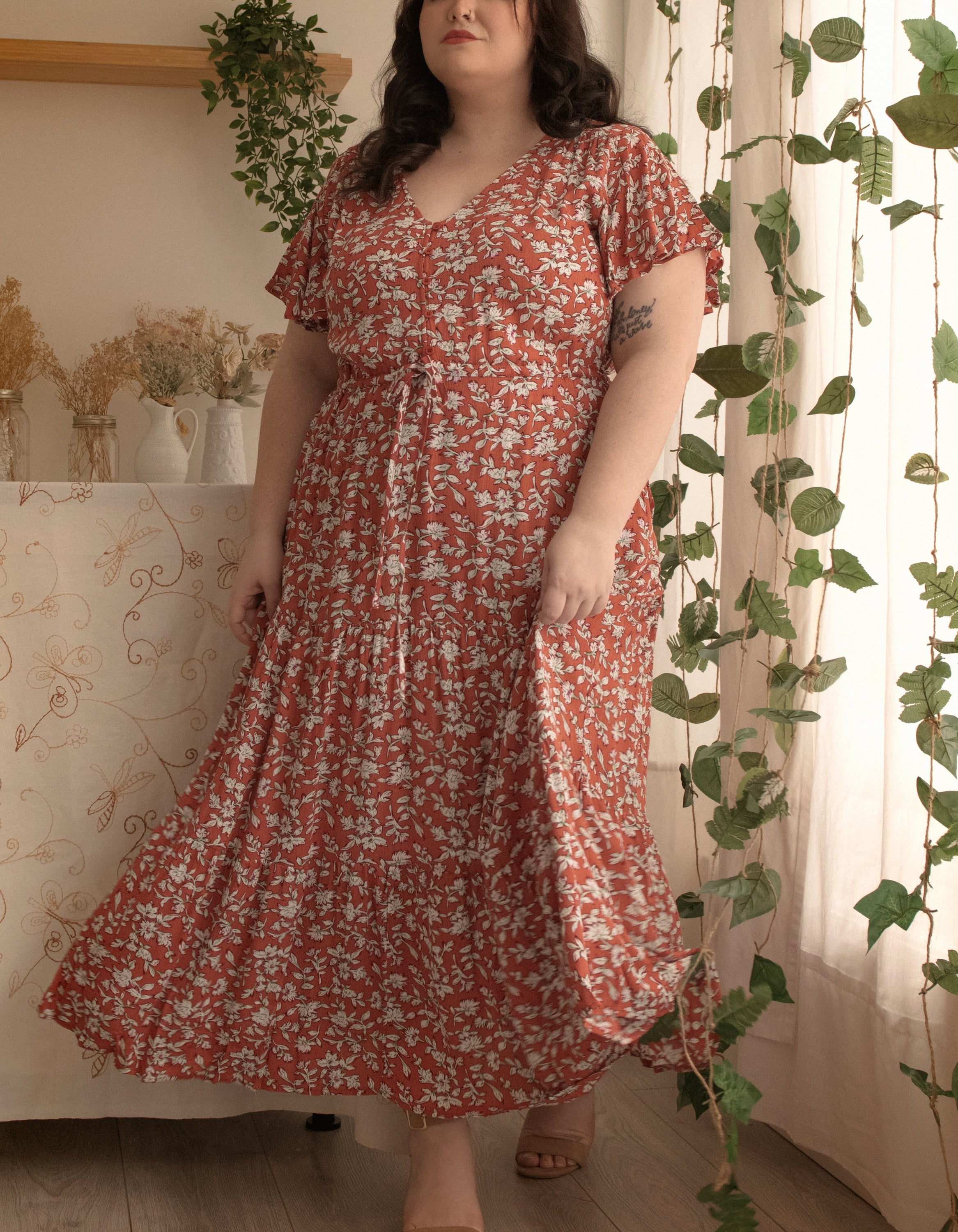 Lysandre Midi Dress in floral print rust with angel sleeves and tiered skirt, showcasing a stylish and comfortable design.