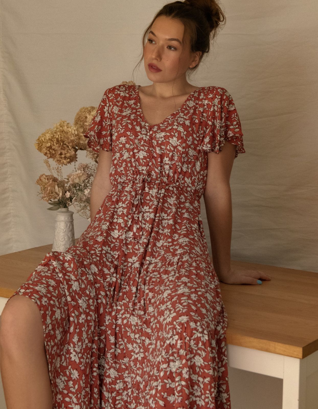 Lysandre Midi Dress in floral print rust with angel sleeves and tiered skirt, showcasing a stylish and comfortable design.