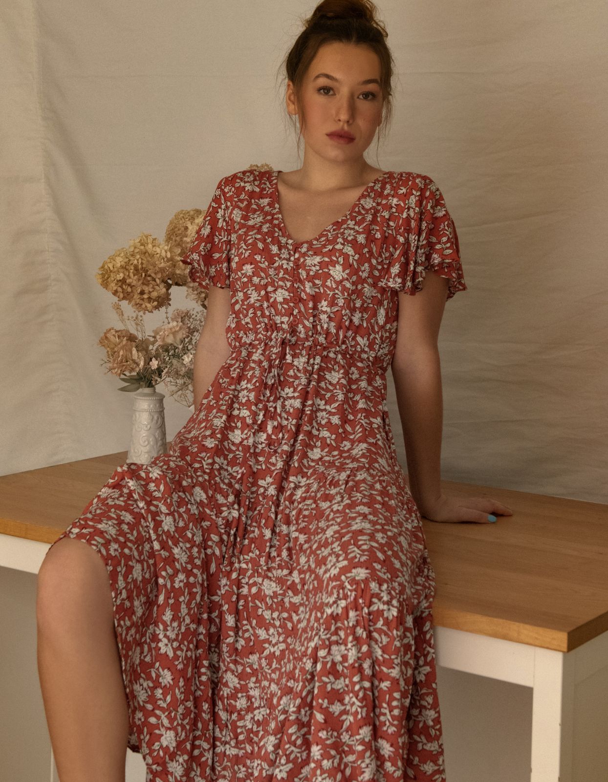 Lysandre Midi Dress in floral print rust with angel sleeves and tiered skirt, showcasing a stylish and comfortable design.