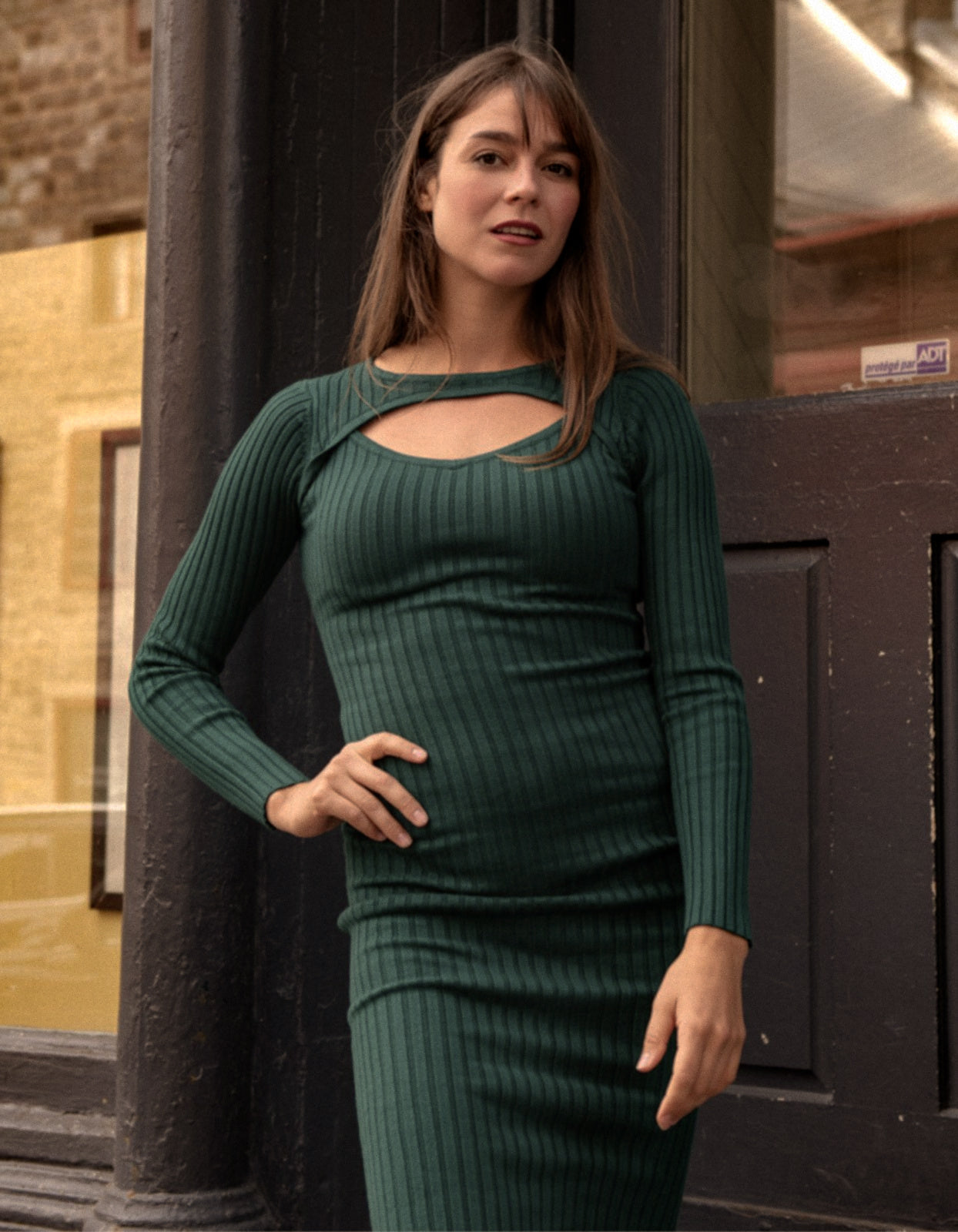 Maddy Dress in hunter green featuring ribbed knitted texture and front cut-out detail, perfect for holiday gatherings.