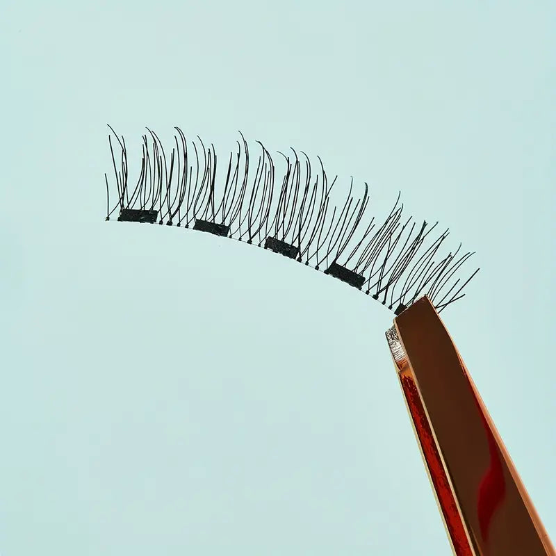 Magnetic Eyelash Kit featuring reusable false eyelashes and applicator tweezer for easy application.