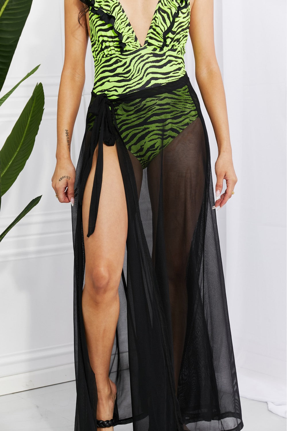 Marina West Swim Beach Is My Runway Mesh Wrap Maxi Cover-Up Skirt displayed on a model at the beach, showcasing its sheer design and elegant wrap feature.