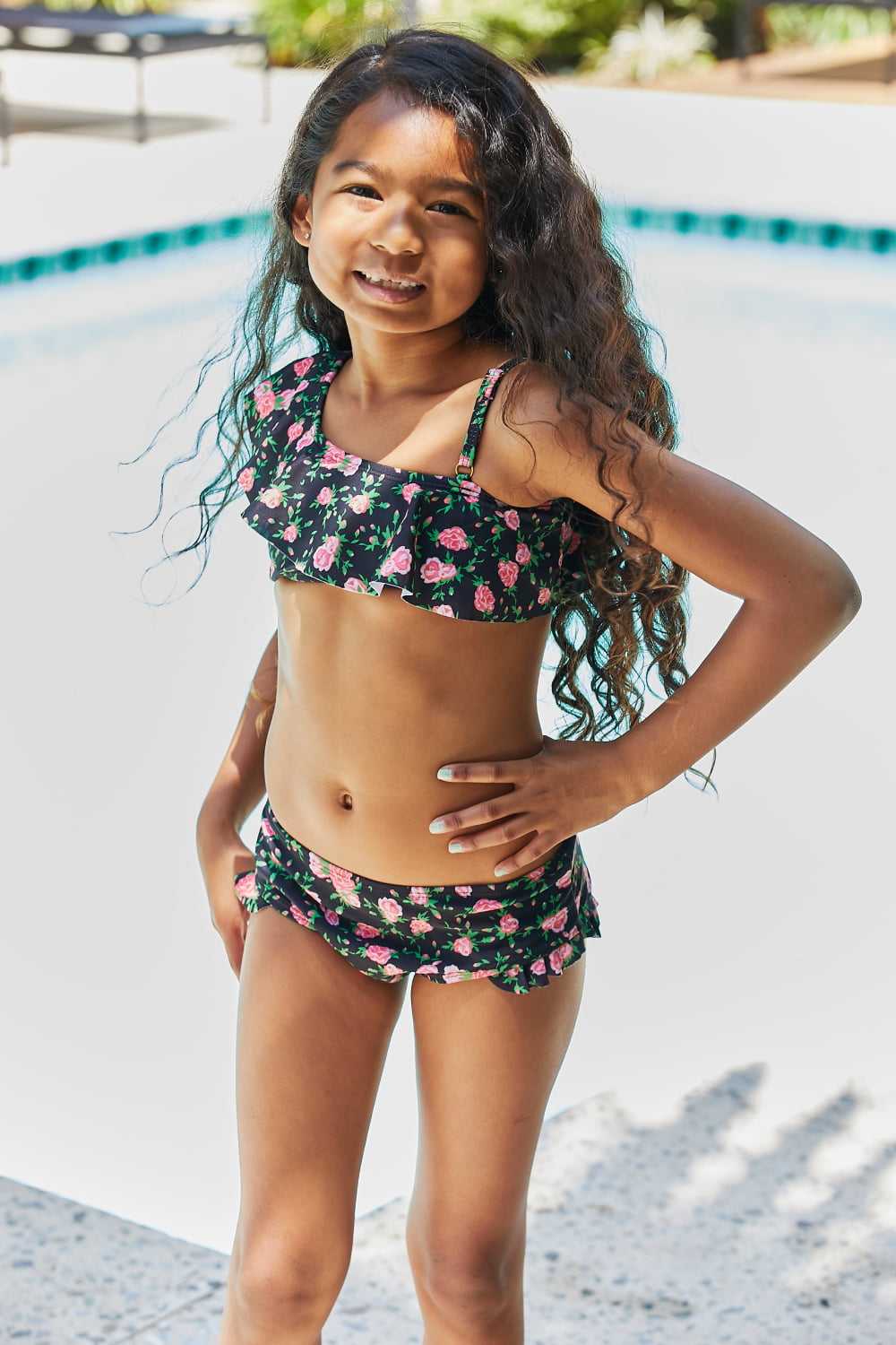 Marina West Swim Clear Waters Two-Piece Swim Set featuring a floral pattern in black roses, ruffled design, and asymmetrical neckline.