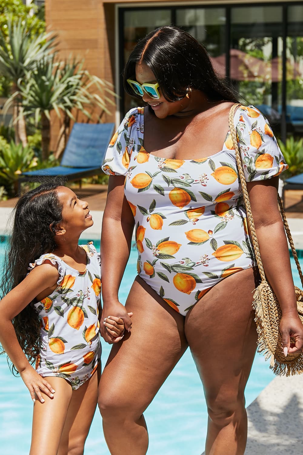 Marina West Swim Salty Air Puff Sleeve One-Piece in vibrant citrus orange with puff sleeves and optional tie belt.