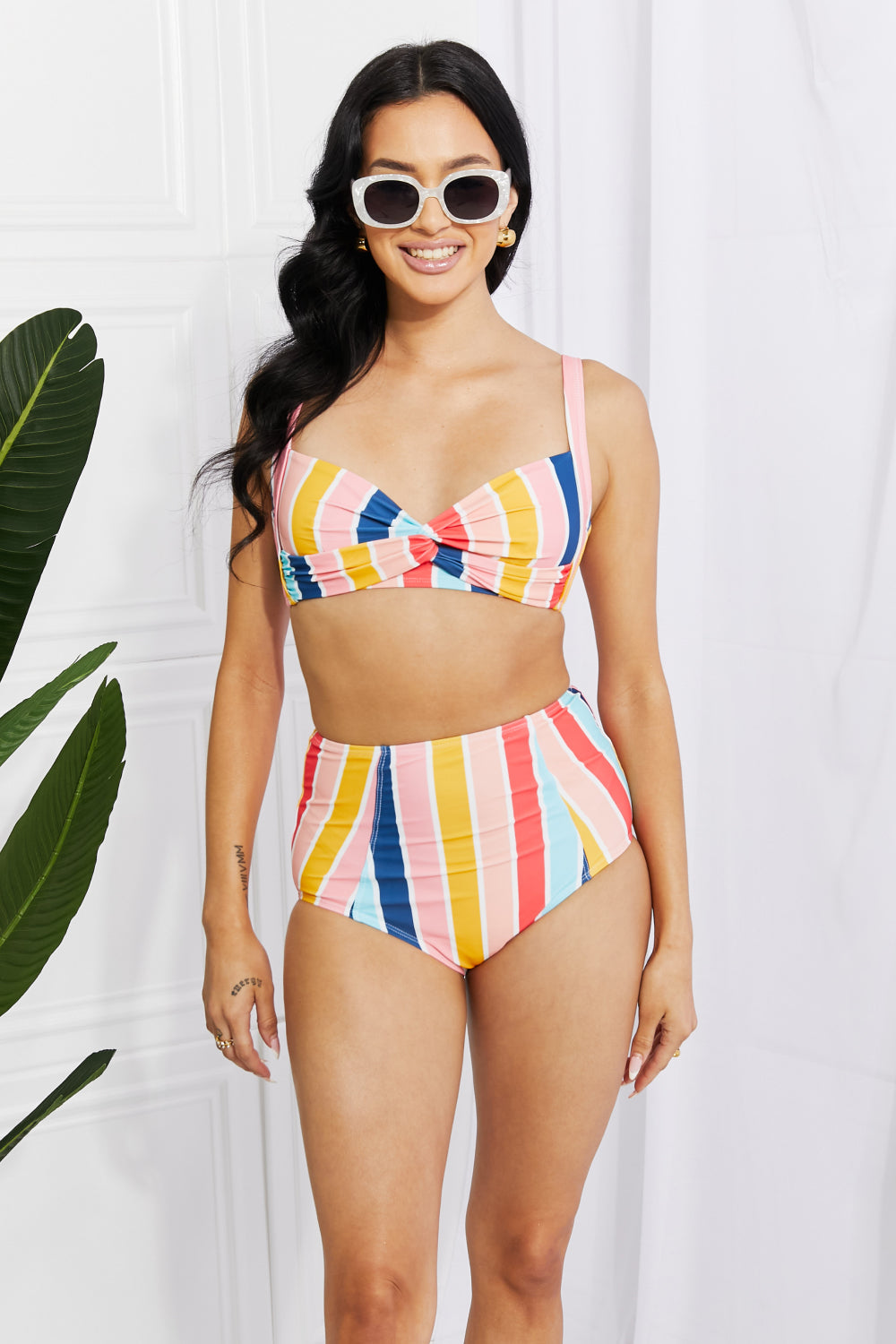 Marina West Swim high-rise bikini featuring a twist-front top and striped pattern, perfect for summer beach outings.