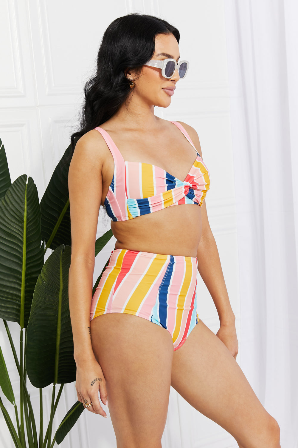 Marina West Swim high-rise bikini featuring a twist-front top and striped pattern, perfect for summer beach outings.