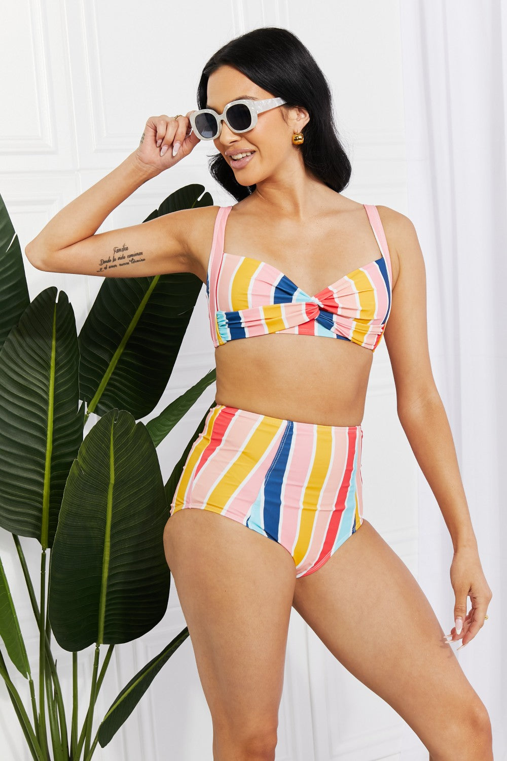 Marina West Swim high-rise bikini featuring a twist-front top and striped pattern, perfect for summer beach outings.