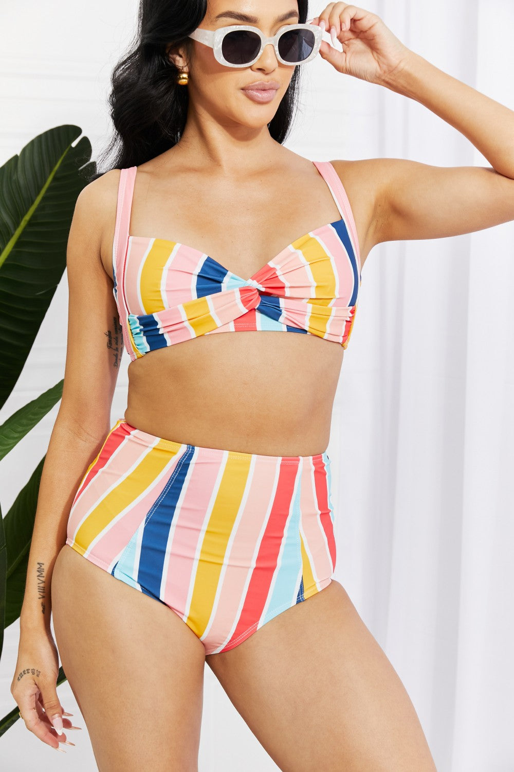 Marina West Swim high-rise bikini featuring a twist-front top and striped pattern, perfect for summer beach outings.