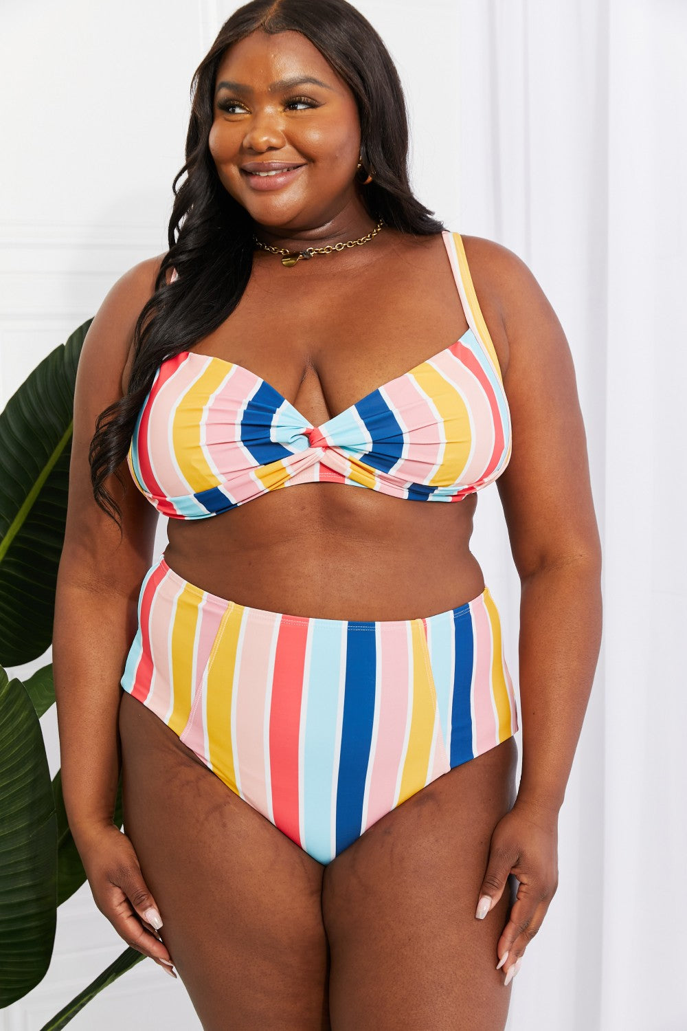 Marina West Swim high-rise bikini featuring a twist-front top and striped pattern, perfect for summer beach outings.