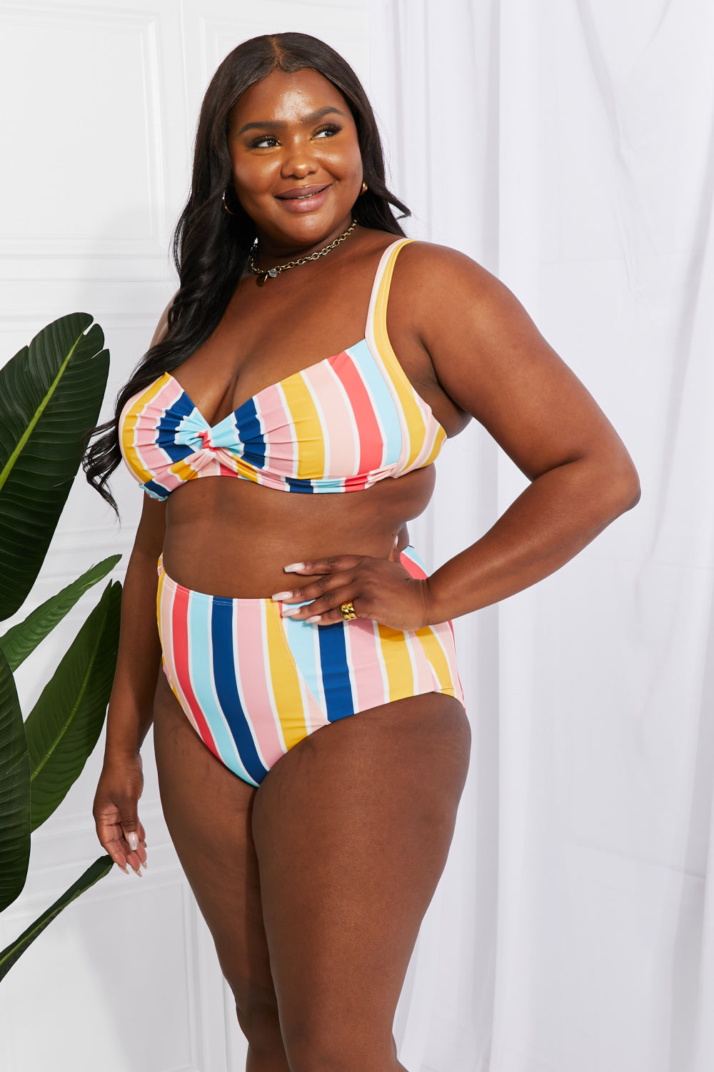 Marina West Swim high-rise bikini featuring a twist-front top and striped pattern, perfect for summer beach outings.