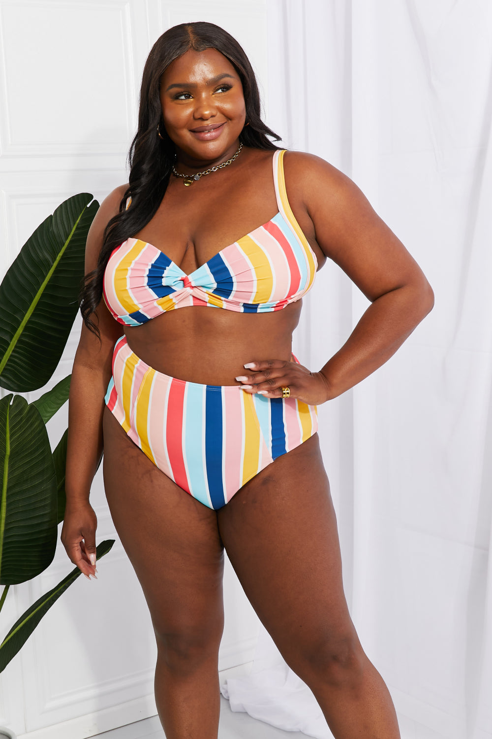 Marina West Swim high-rise bikini featuring a twist-front top and striped pattern, perfect for summer beach outings.