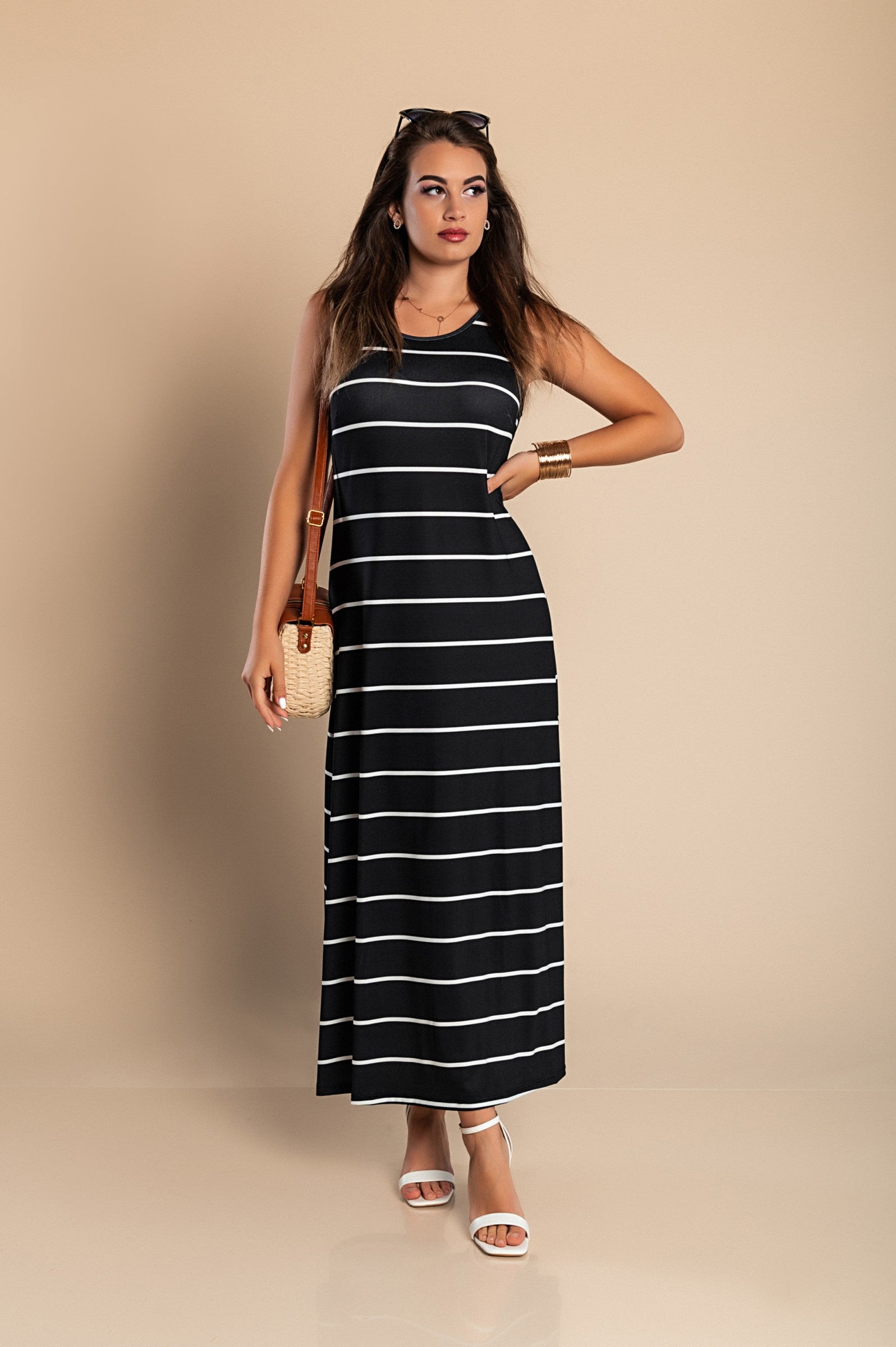 Elegant black maxi dress with striped print, featuring a round neckline and side slit.