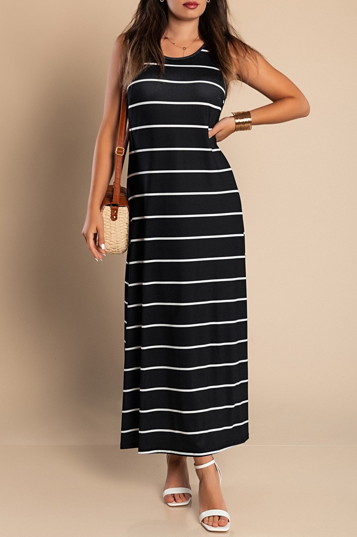 Elegant black maxi dress with striped print, featuring a round neckline and side slit for added style.