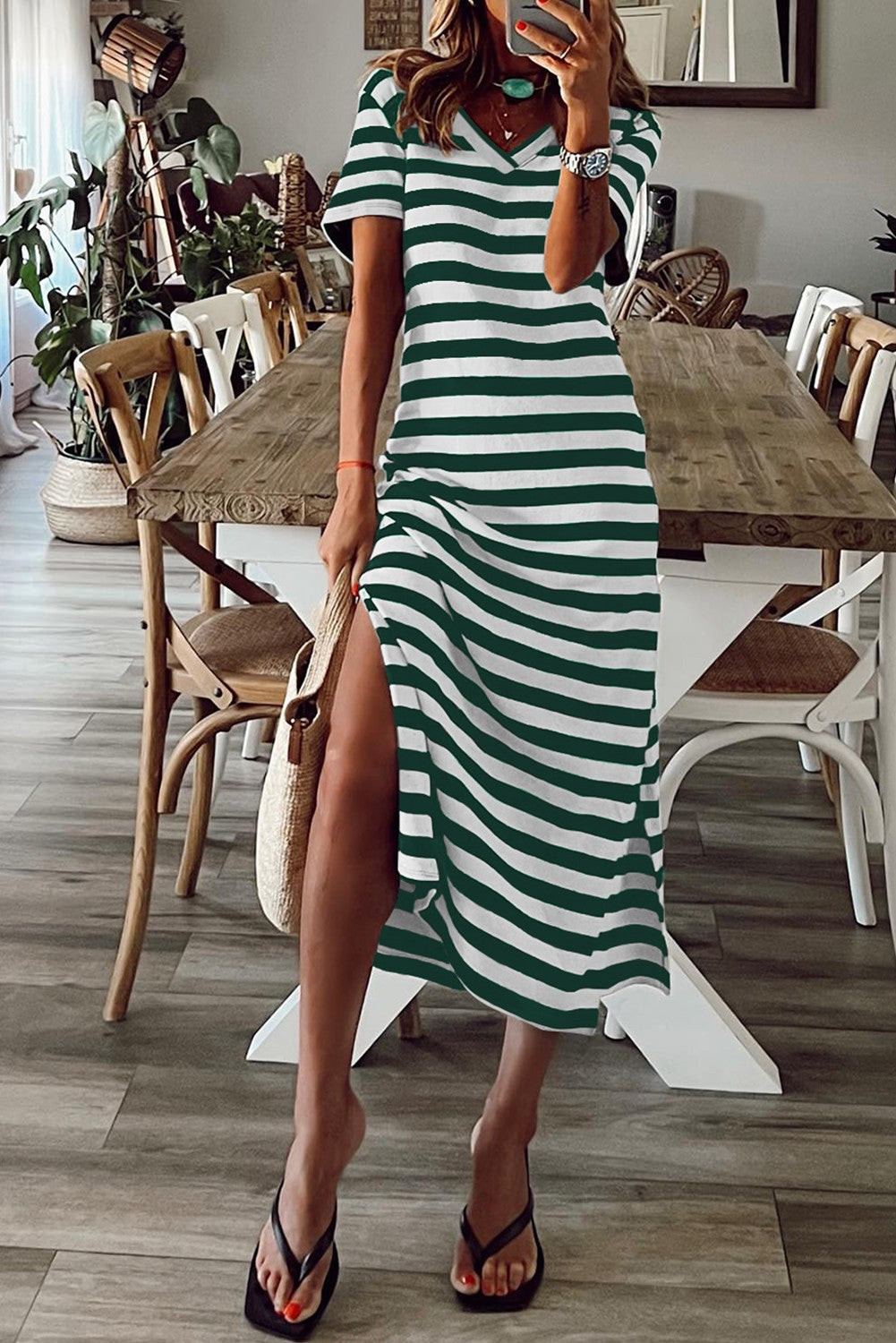 A stylish green maxi dress featuring a striped print, V-neckline, and short flowing sleeves, perfect for summer occasions.