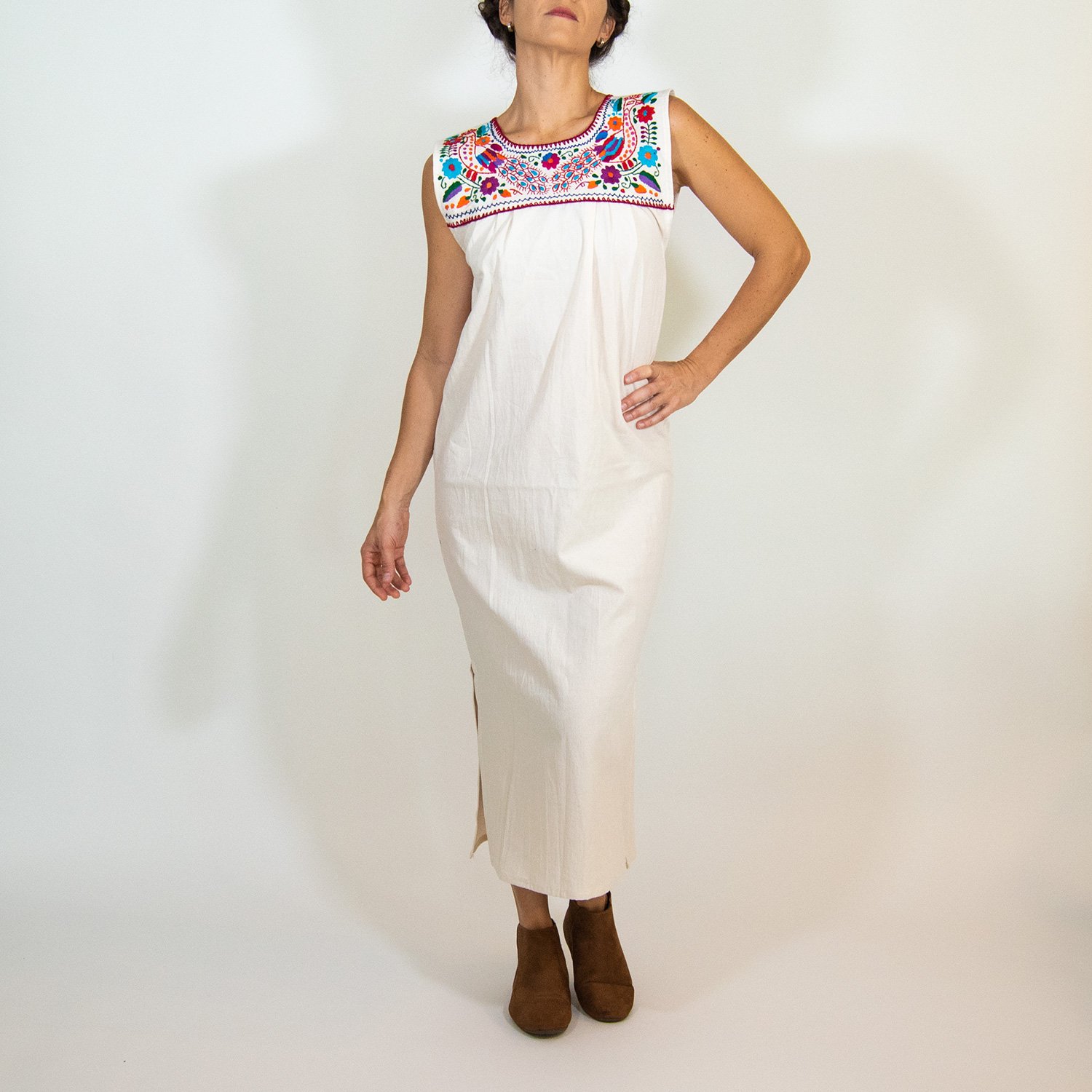 Maxi Isidra white Mexican embroidered dress featuring colorful floral designs on soft cotton fabric, showcasing artisan craftsmanship.