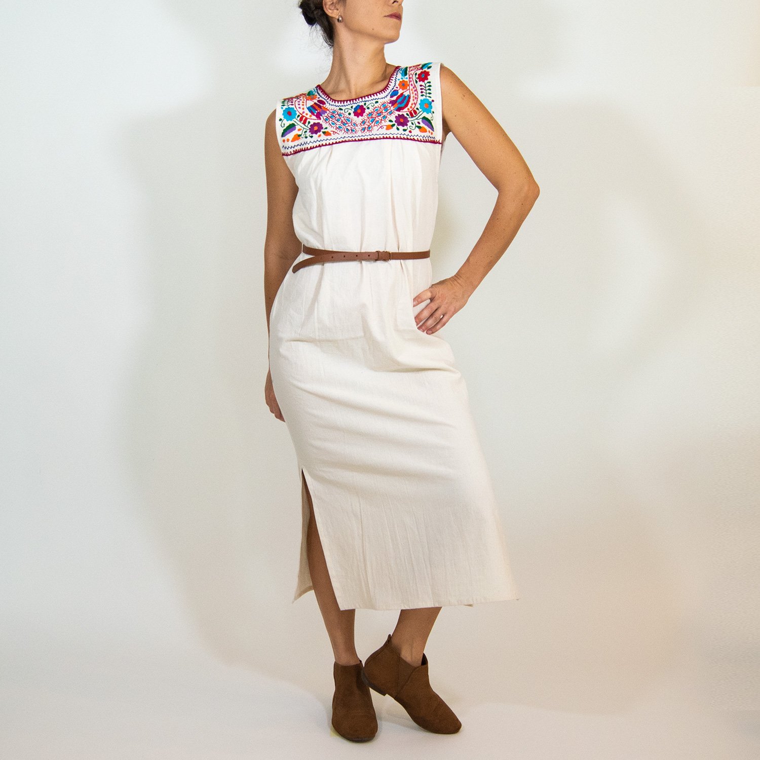 Maxi Isidra white Mexican embroidered dress featuring colorful floral designs on soft cotton fabric, showcasing artisan craftsmanship.