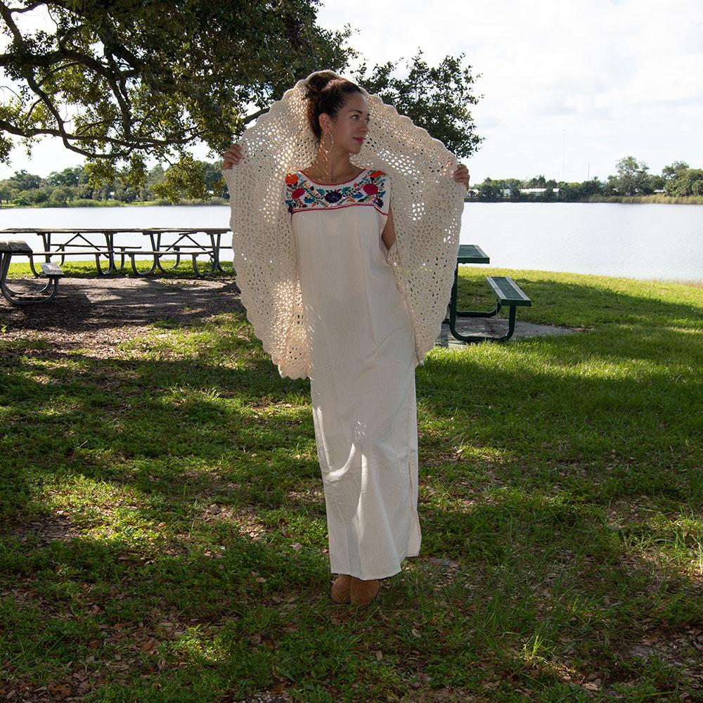 Maxi Isidra white Mexican embroidered dress featuring colorful floral designs on soft cotton fabric, showcasing artisan craftsmanship.