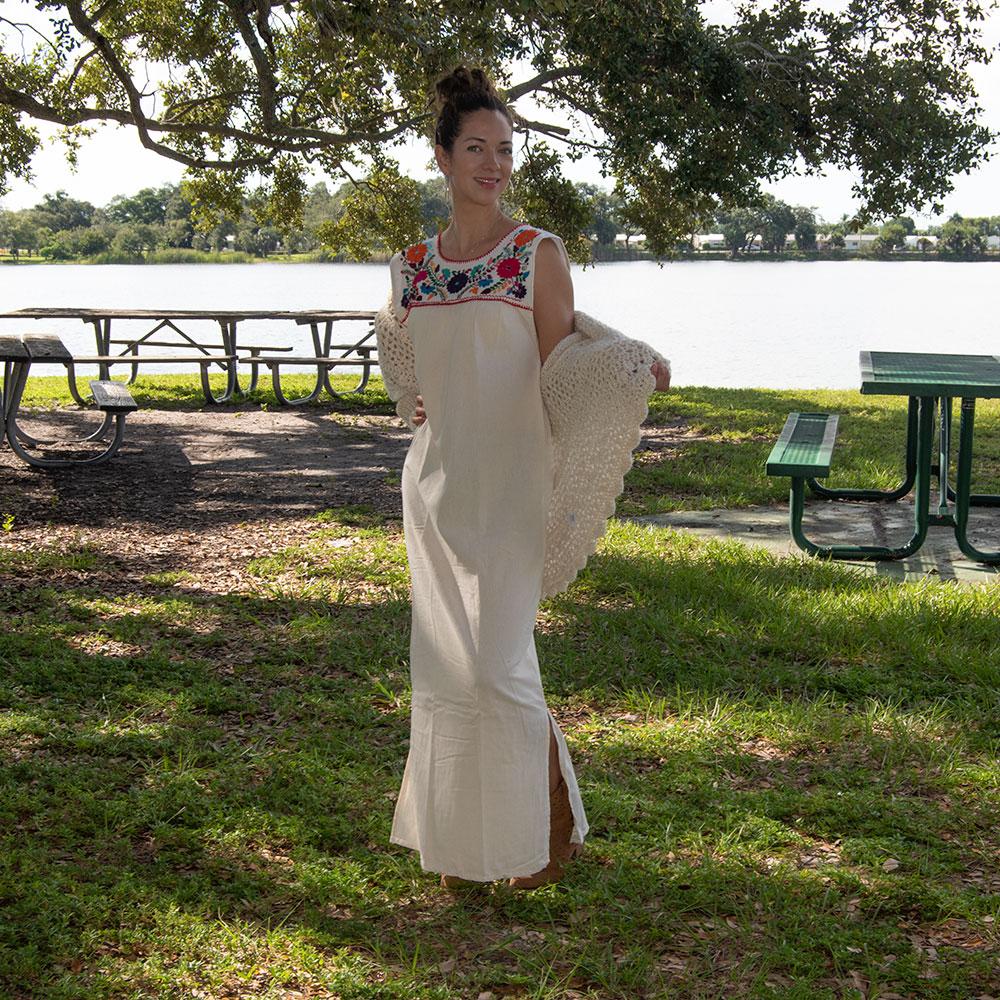 Maxi Isidra white Mexican embroidered dress featuring colorful floral designs on soft cotton fabric, showcasing artisan craftsmanship.