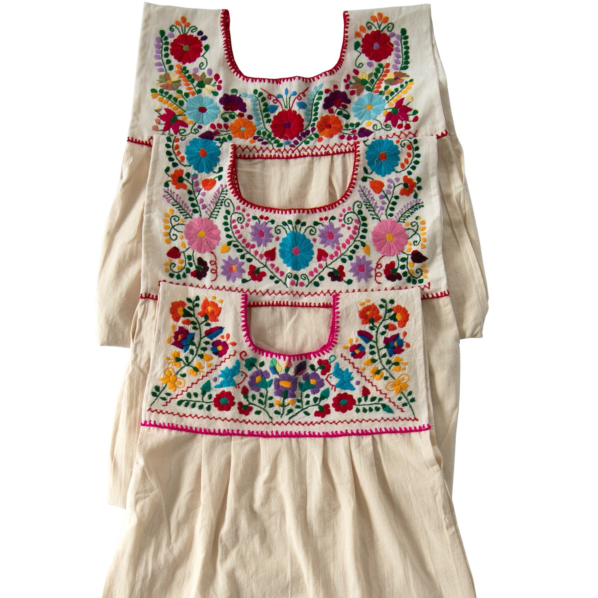 Maxi Isidra white Mexican embroidered dress featuring colorful floral designs on soft cotton fabric, showcasing artisan craftsmanship.