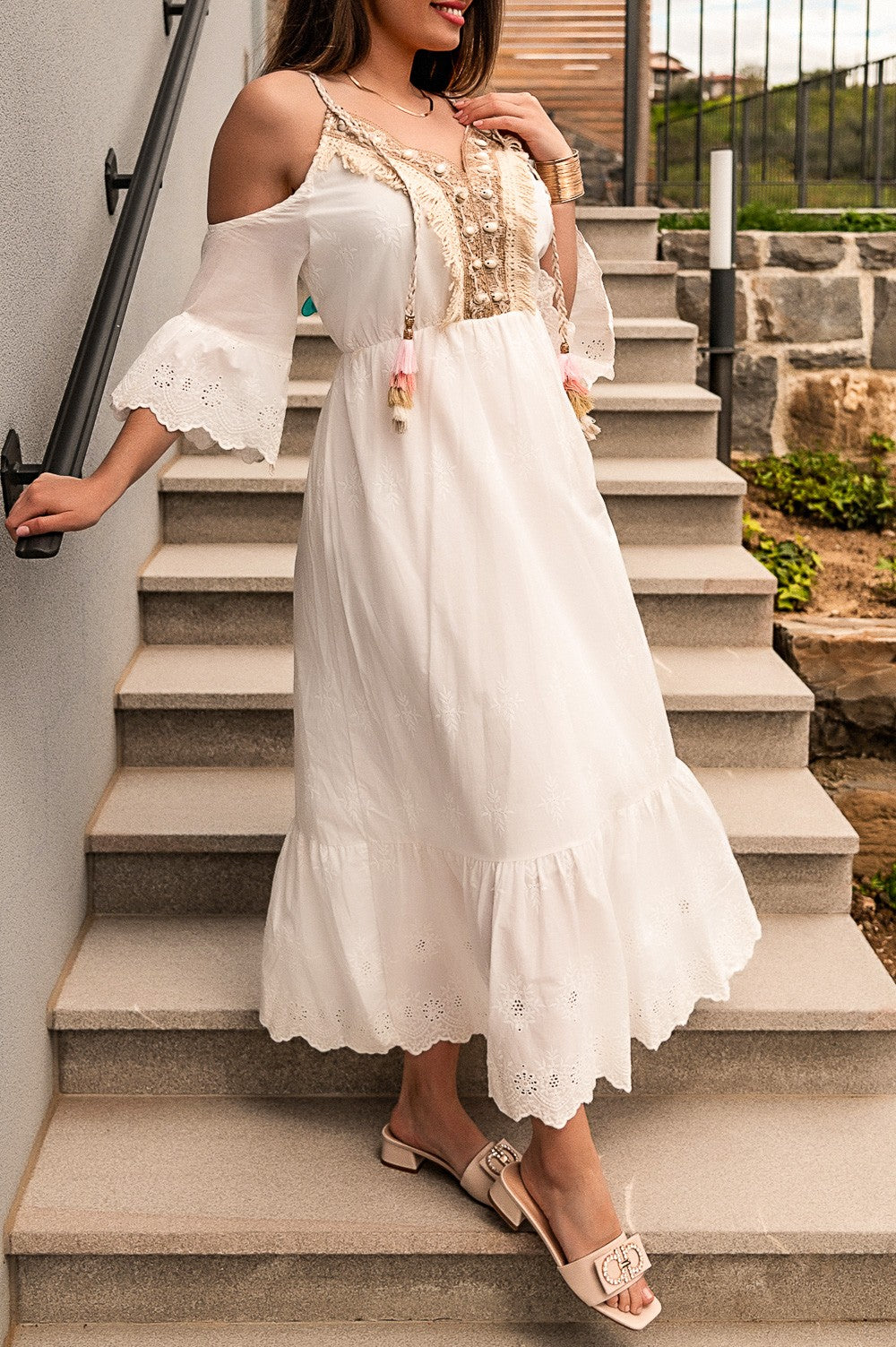 White maxi summer dress with embroidery details, featuring thin straps and a V-neckline, perfect for beach outings.