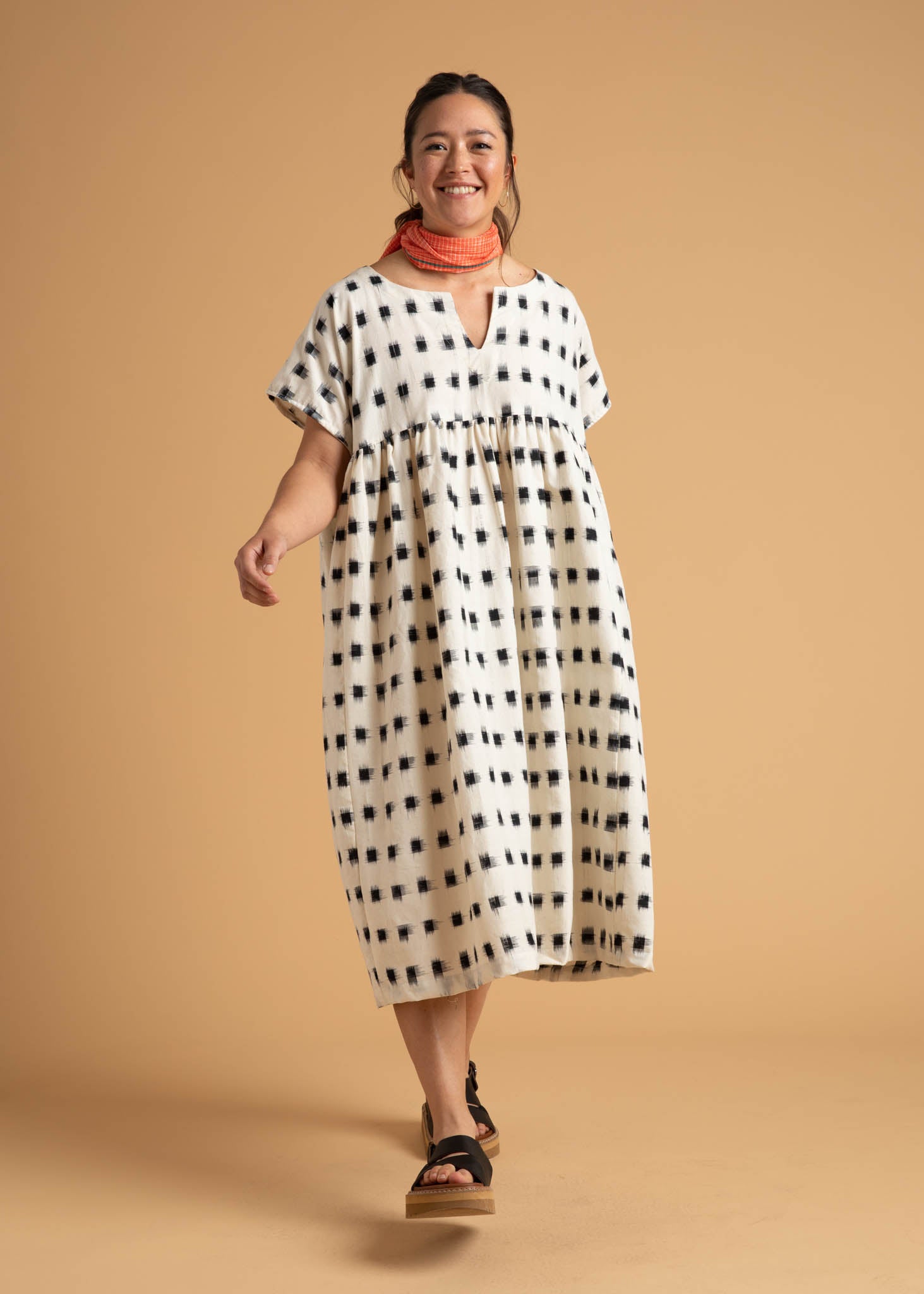 The Meadow Dress in Ikat Squares pattern, showcasing its flowy design, semi V-neck, and hidden side pockets.