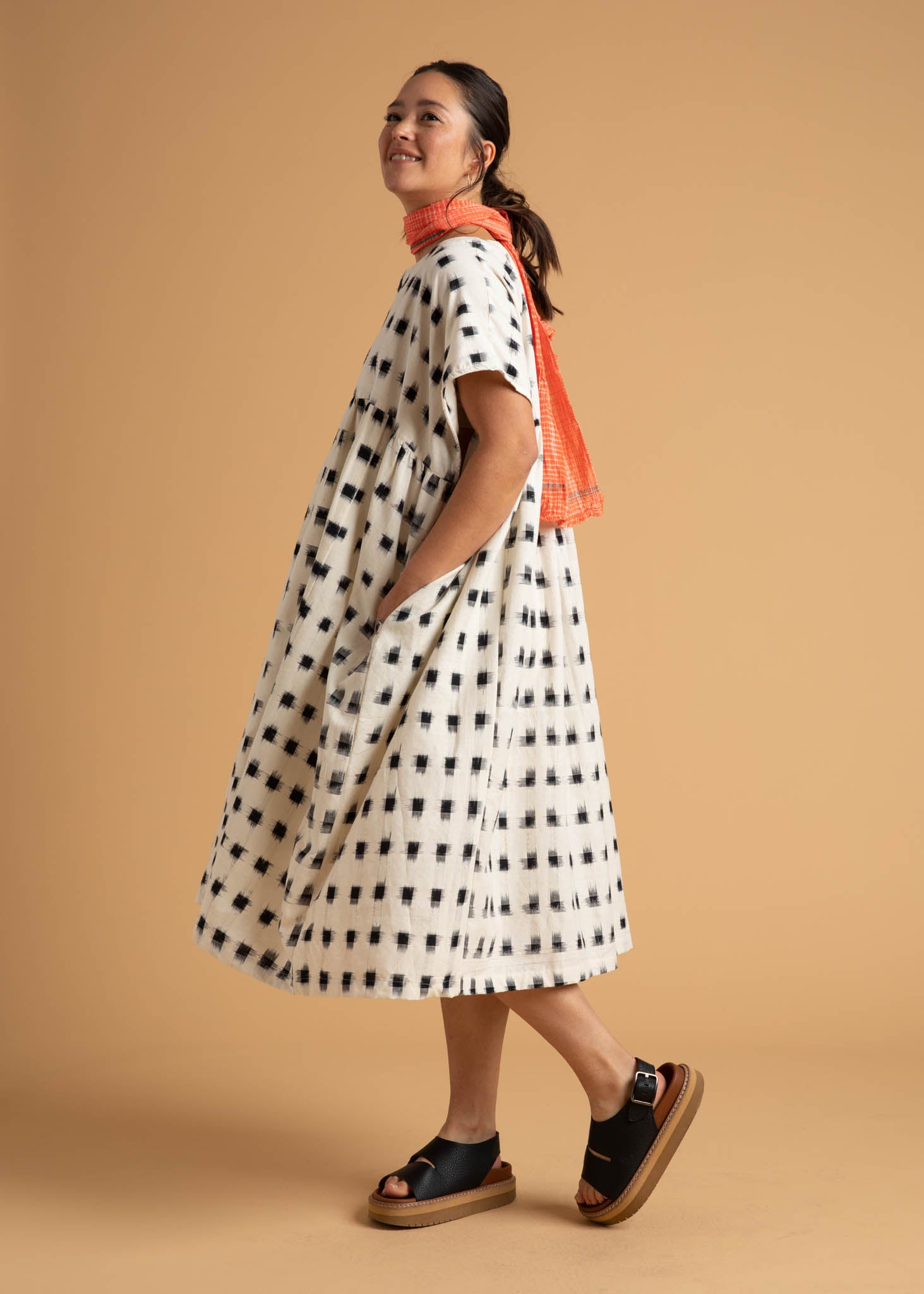 The Meadow Dress in Ikat Squares pattern, showcasing its flowy design, semi V-neck, and hidden side pockets.