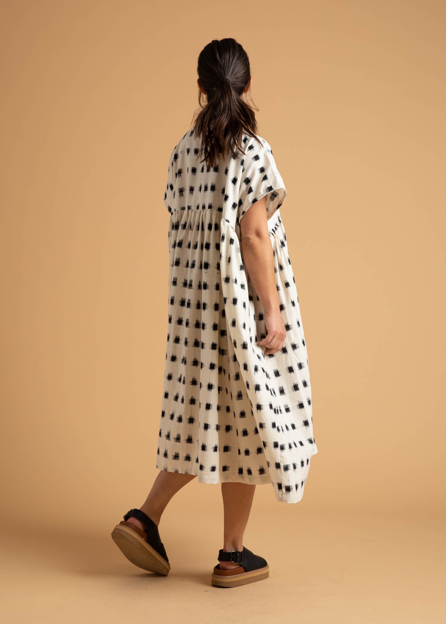 The Meadow Dress in Ikat Squares pattern, showcasing its flowy design, semi V-neck, and hidden side pockets.