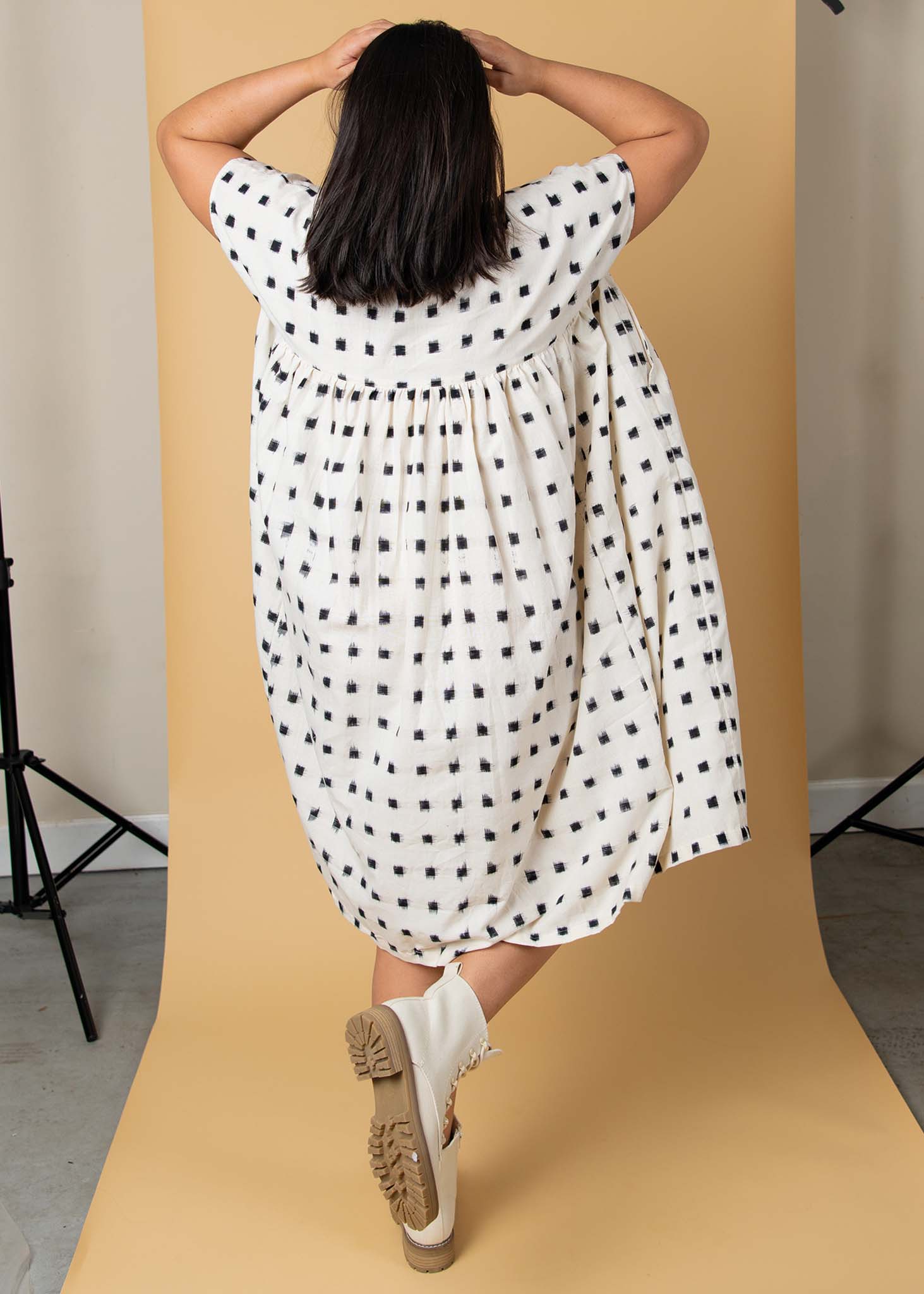 The Meadow Dress in Ikat Squares pattern, showcasing its flowy design, semi V-neck, and hidden side pockets.