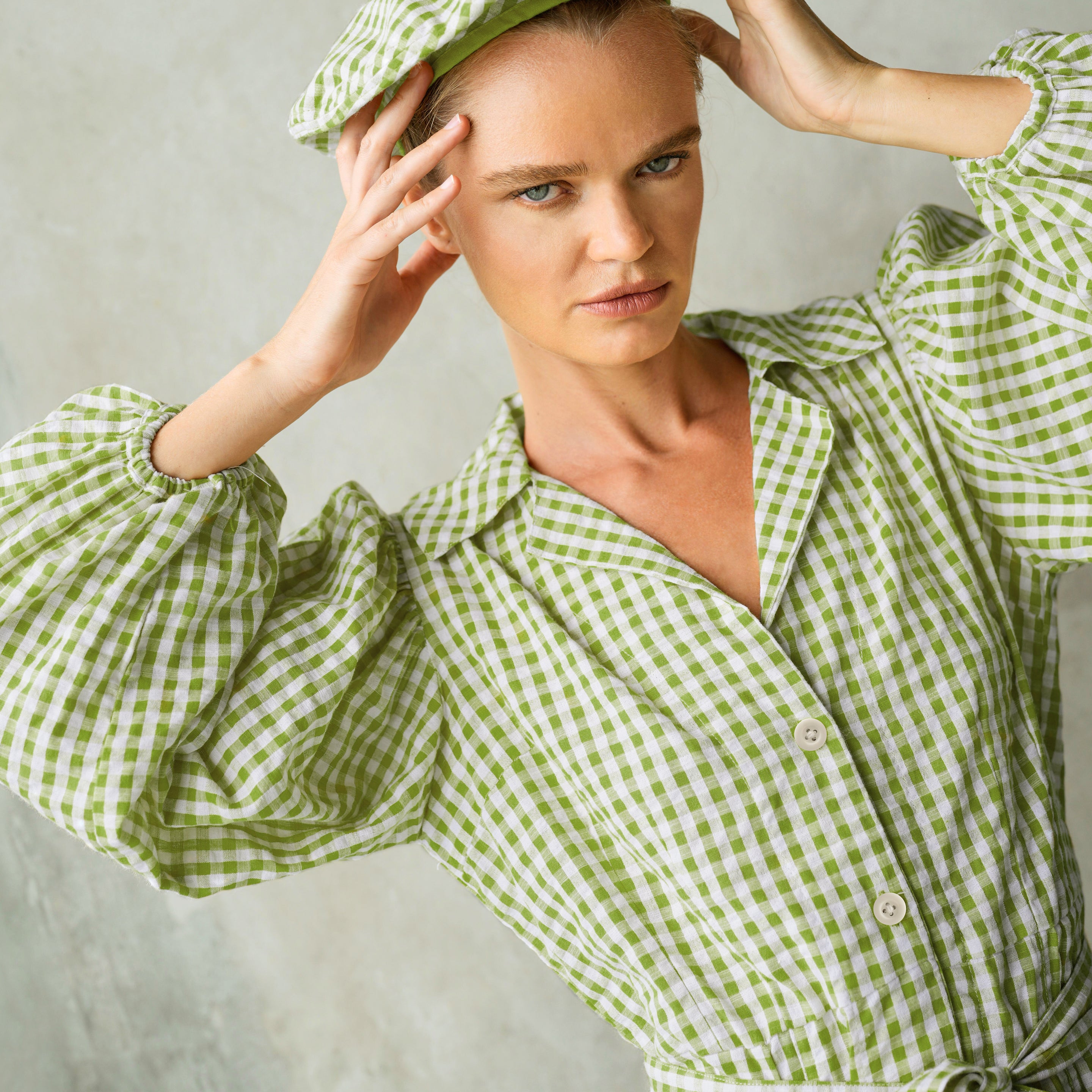 Olive green Meghan mini gingham dress featuring puff sleeves and a removable waist belt, perfect for casual outings.