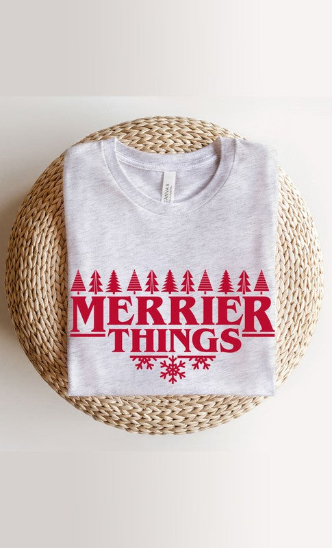 Merrier Things Festive Christmas PLUS Graphic Tee featuring a colorful holiday graphic design on a soft cotton blend fabric.