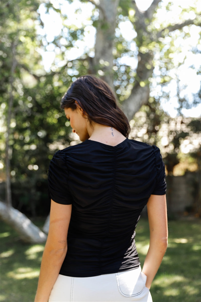 A stylish black mesh ruched cut-out detail short sleeve top, featuring a fitted design and trendy front cut-out with hook & eye closure.