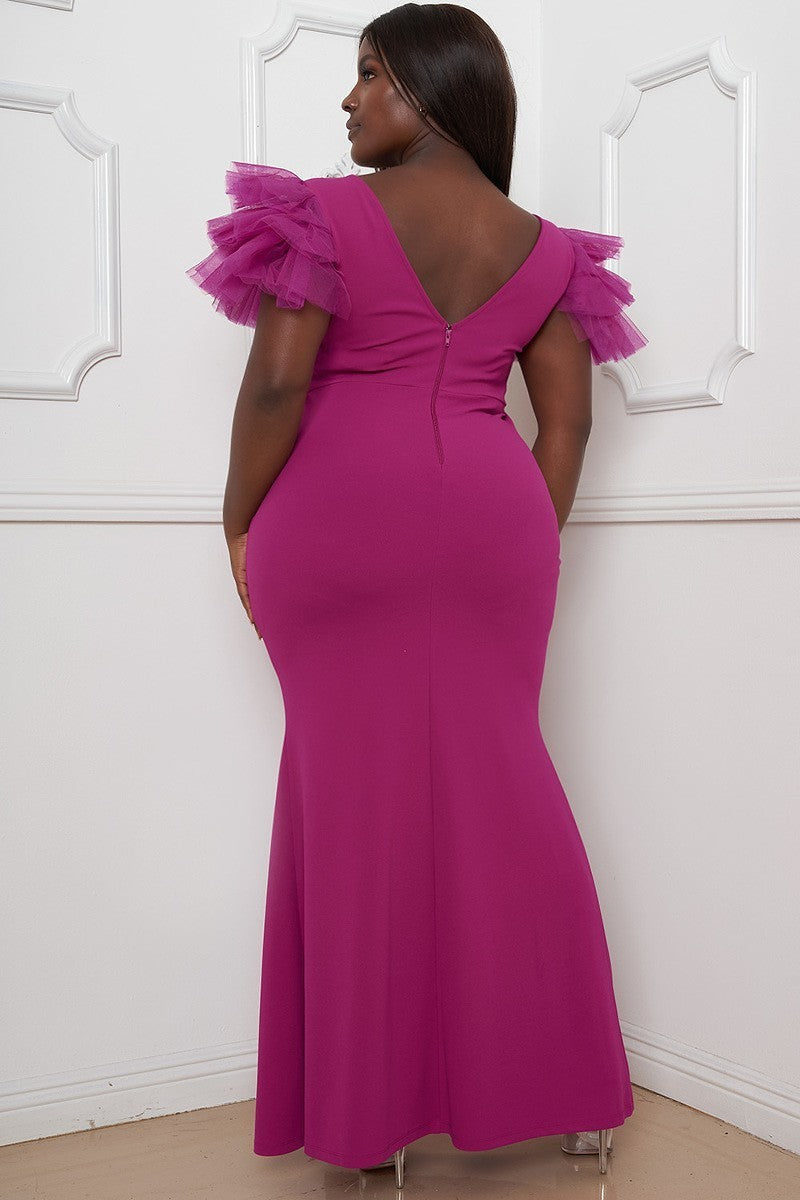 A vibrant hot magenta plus size maxi dress featuring mesh tulle shoulders, a surplice neckline, pleated details, and a left side slit.