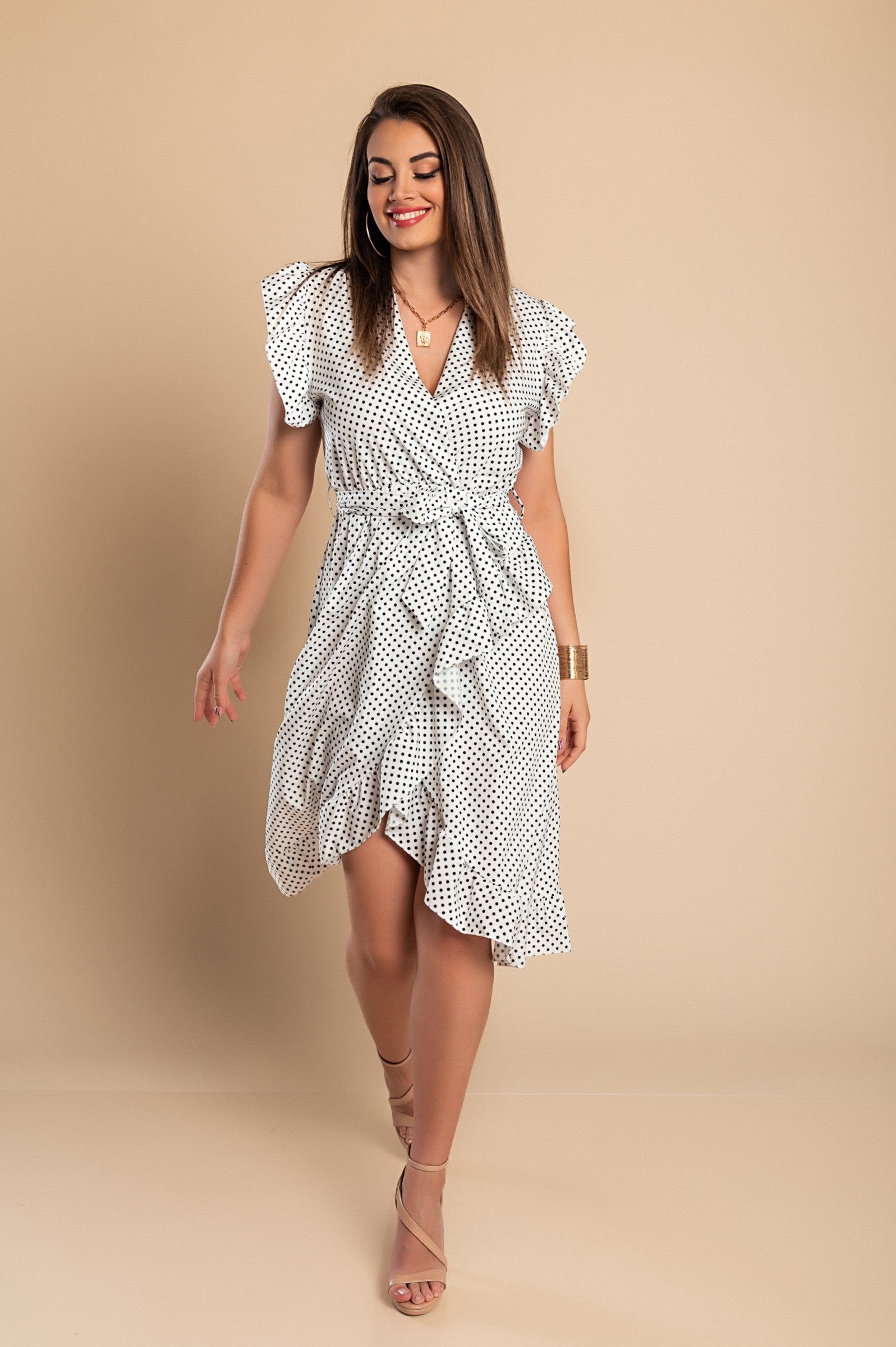 Elegant white midi dress with polka dot print, featuring a deep V-neckline and ruffled sleeves, perfect for stylish occasions.