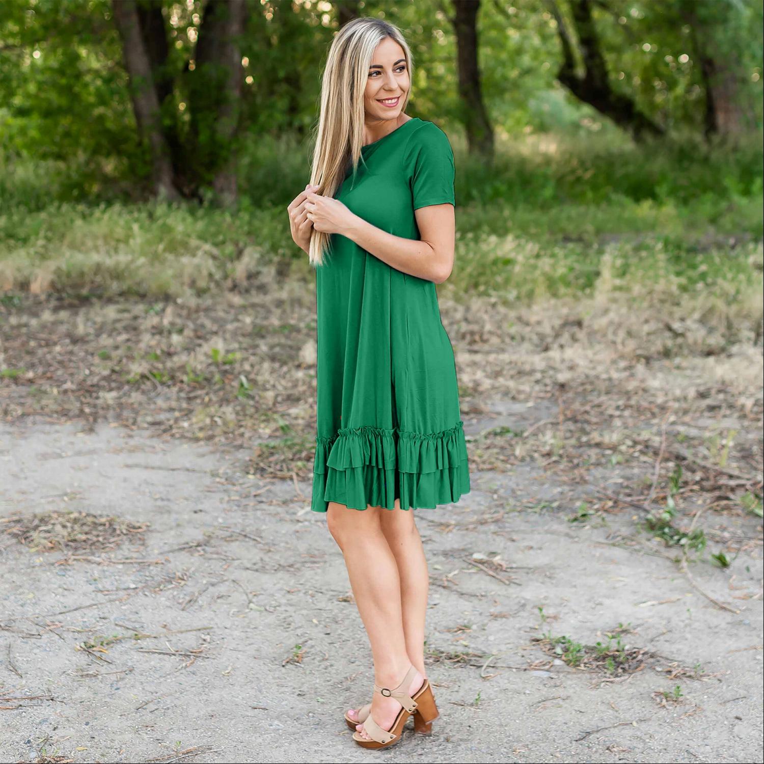 A stylish midi dress featuring short sleeves, cute pocket embellishments, and a ruffled hemline, perfect for any occasion.