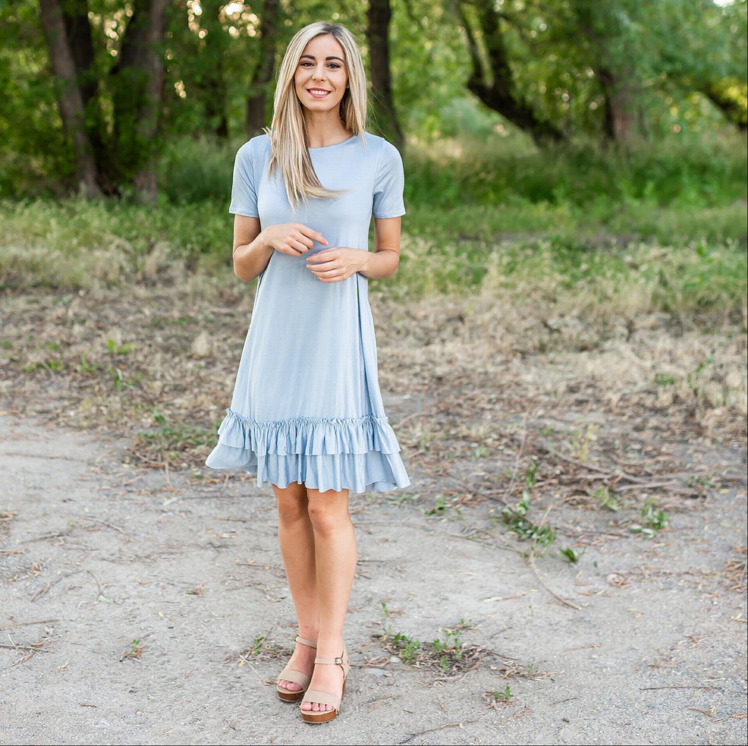 A stylish midi dress featuring short sleeves, cute pocket embellishments, and a ruffled hemline, perfect for any occasion.