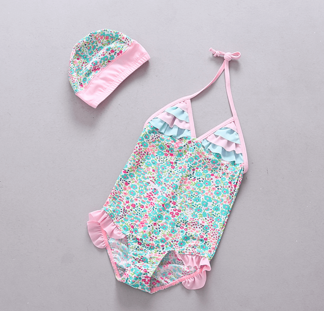 Millaray swimsuit featuring a vibrant print and cute ruffles, perfect for girls at the beach or pool.