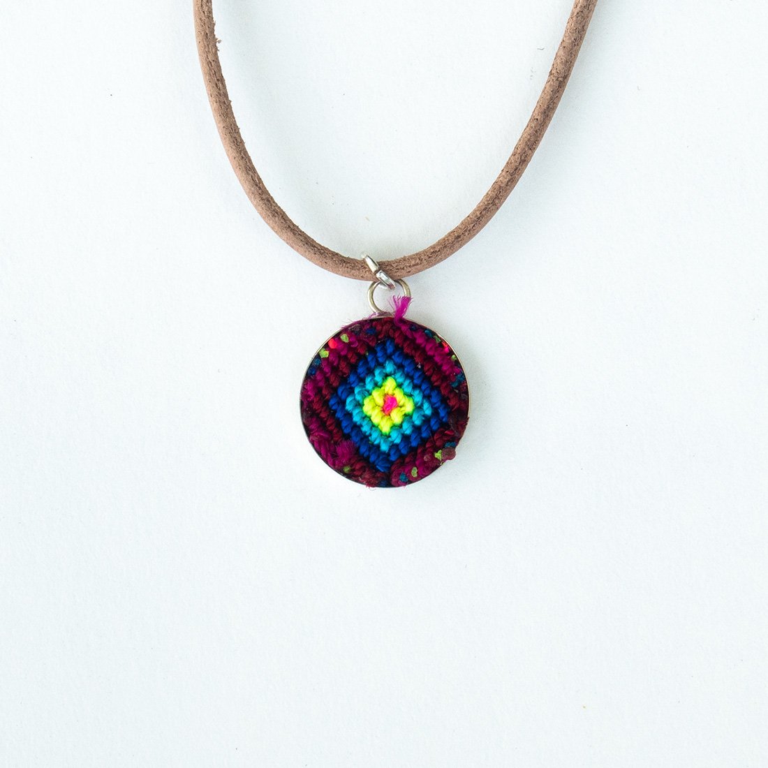 Mini Circle Friendship Necklace featuring a colorful textile pendant and leather string, handcrafted using traditional Chamula weaving techniques.