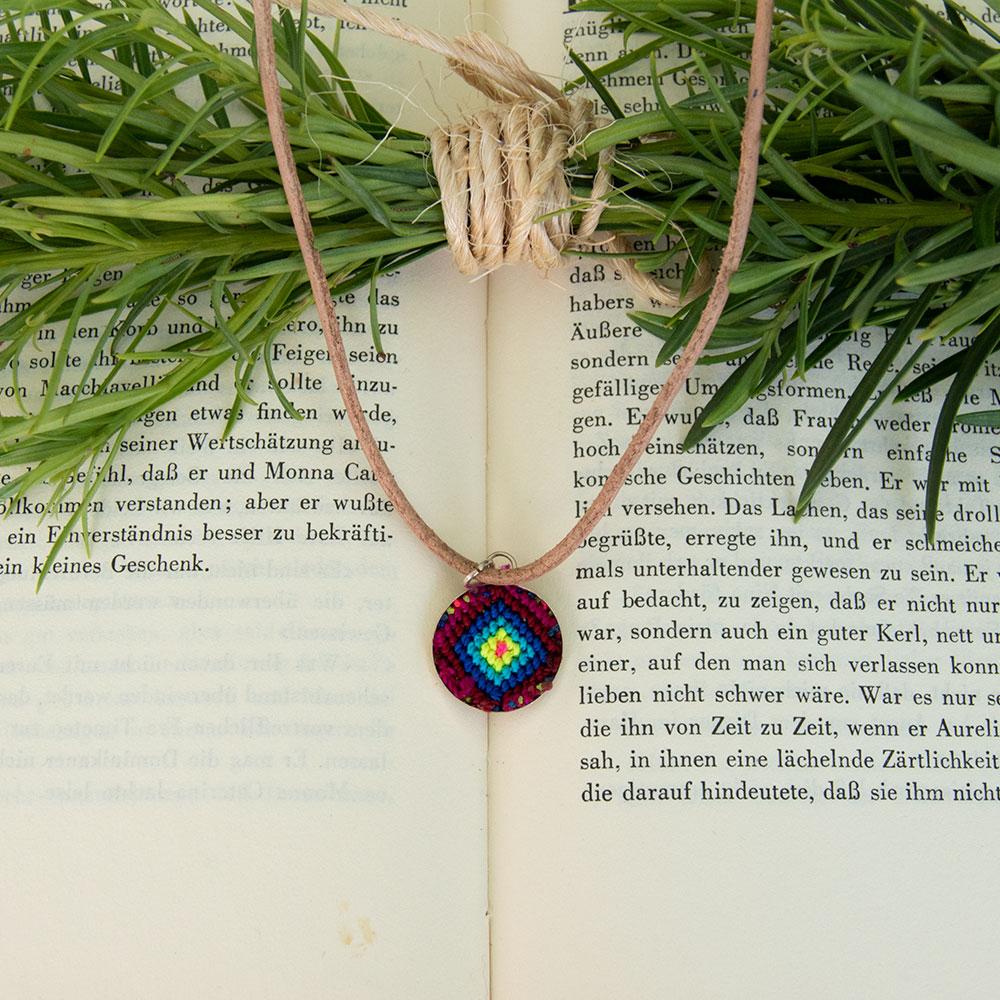 Mini Circle Friendship Necklace featuring a colorful textile pendant and leather string, handcrafted using traditional Chamula weaving techniques.