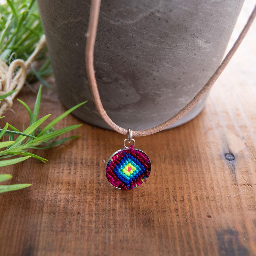 Mini Circle Friendship Necklace featuring a colorful textile pendant and leather string, handcrafted using traditional Chamula weaving techniques.