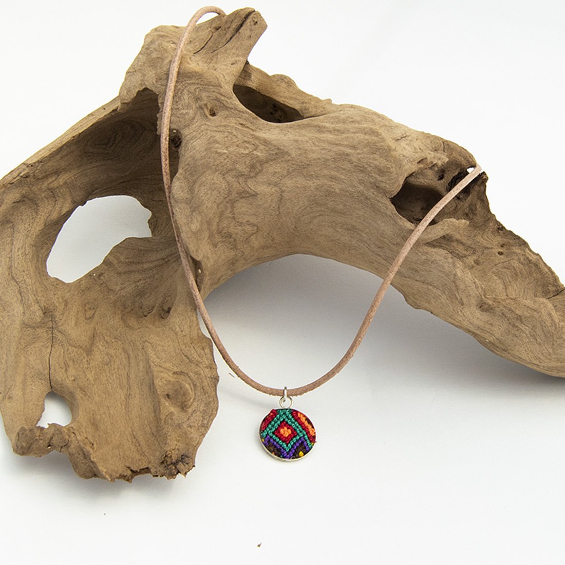 Mini Circle Friendship Necklace featuring a colorful textile pendant and leather string, handcrafted using traditional Chamula weaving techniques.