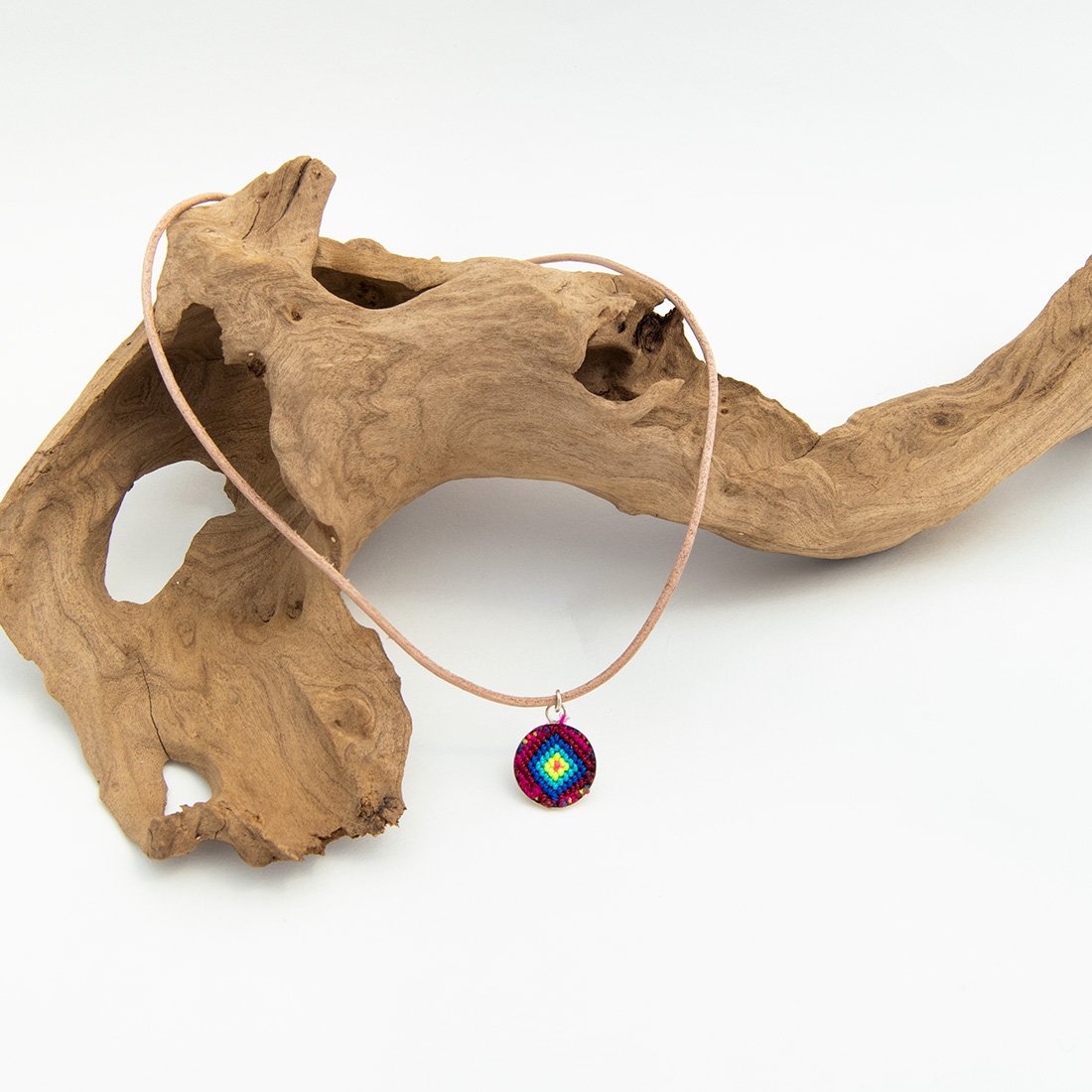 Mini Circle Friendship Necklace featuring a colorful textile pendant and leather string, handcrafted using traditional Chamula weaving techniques.